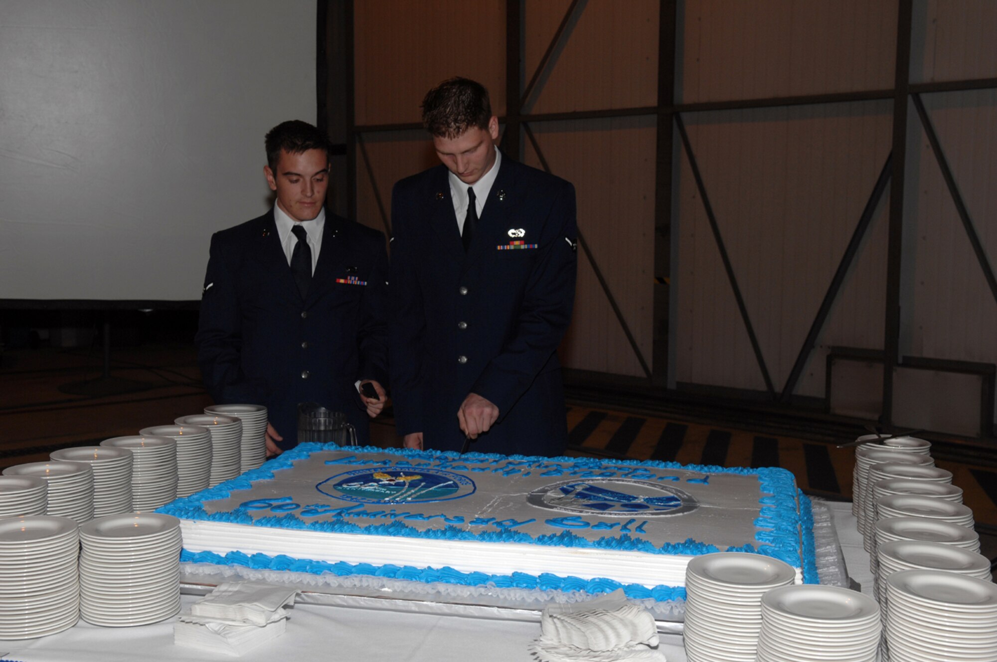 Two of the most junior Airmen cut cake at the RAF Lakenheath 60th Anniversary Air Force ball Sept. 8. (U.S. Air Force photo by Tech. Sgt. Sabrina Johnson)