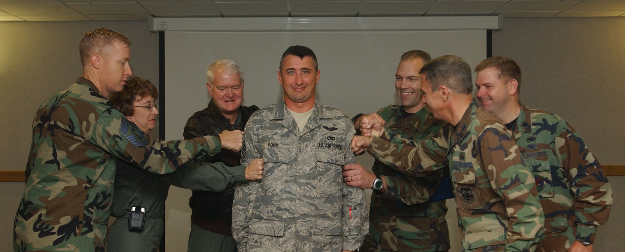 From left, Command Chief Master Sgt. Michael J. Warner, 100th Air Refueling Wing  command chief, Col. Eden J. Murrie, 100th ARW commander, and Lt. Gen. Robert D. Bishop, 3rd Air Force commander, tack master sergeant stripes on Tech. Sgt. Charles H. Pope, center, during a Stripes for Exceptional Performers promotion ceremony Monday. Also assisting are Chief Master Sgt. Martin Klukas, 3rd Air Force command chief, Col. Michael Saville,100th Maintenance Group commander, and Lt. Col. Michael Braucher, 100th Aircraft Maintenance Squadron commander. (U.S Air Force photo by Airman Brad Smith)                                 