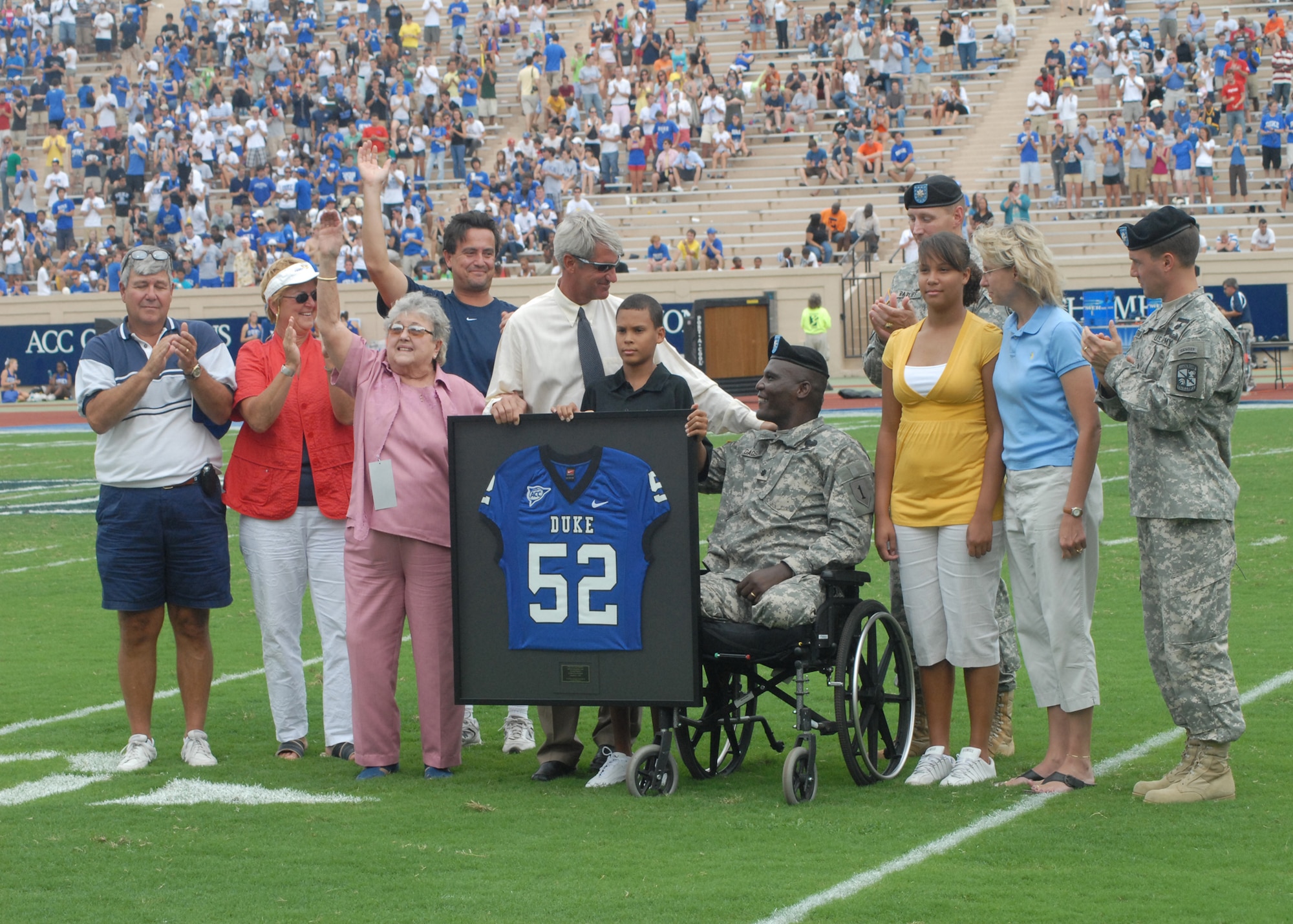 Army Lt. Col. Greg Gadson receives a retired football jersey Sept. 1 from Duke's Director of Athletics Joe Alleva on behalf of the Wounded Warrior Program at Walter Reed Army Medical Center. Colonel Gadson was injured by an improvised explosive device while riding in a humvee in support of the War on Terror. The presentation was part of the Military Appreciation Game during Duke's college football season opener.  (U.S. Air Force photo/Staff Sgt. Jon LaDue)