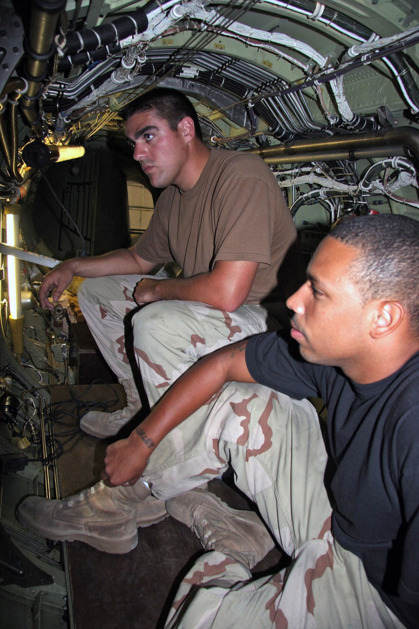 Staff Sgt. Justin Hicks (left) reviews maintenance completed on a U-2 aircraft with Airman 1st Class Alejandro Betancourt while deployed to a base in Southwest Asia.  Sergeant Hicks saved a choking Airman in the Oasis dining facility Sept. 1. Sergeant Hicks is a U-2 crew chief currently assigned to the 99th Aircraft Maintenance Squadron here and is deployed from the 9th Aircraft Squadron at Beale Air Force Base, Calif. (U.S. Air Force photo/Master Sgt. Ruby Zarzyczny)