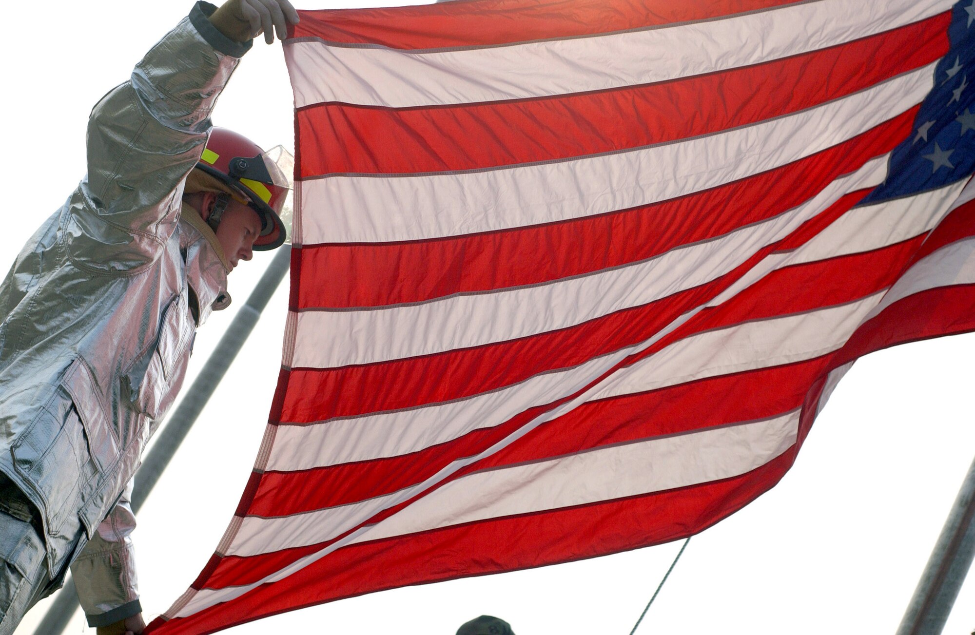 Tech. Sgt. Jason Rosenbaum helps raise the flag during the Sept. 11, 2001, remembrance ceremony Sept. 11 at Kunsan Air Base, South Korea. Sergeant Rosenbaum was the project coordinator for the ceremony marking the sixth anniversary of the terrorist attacks in New York City, the Pentagon and Shanksville, Pa. Sergeant Rosenbaum is a firefighter with the 8th Civil Engineer Squadron. (U.S. Air Force photo/Senior Airman Steven R. Doty) 
