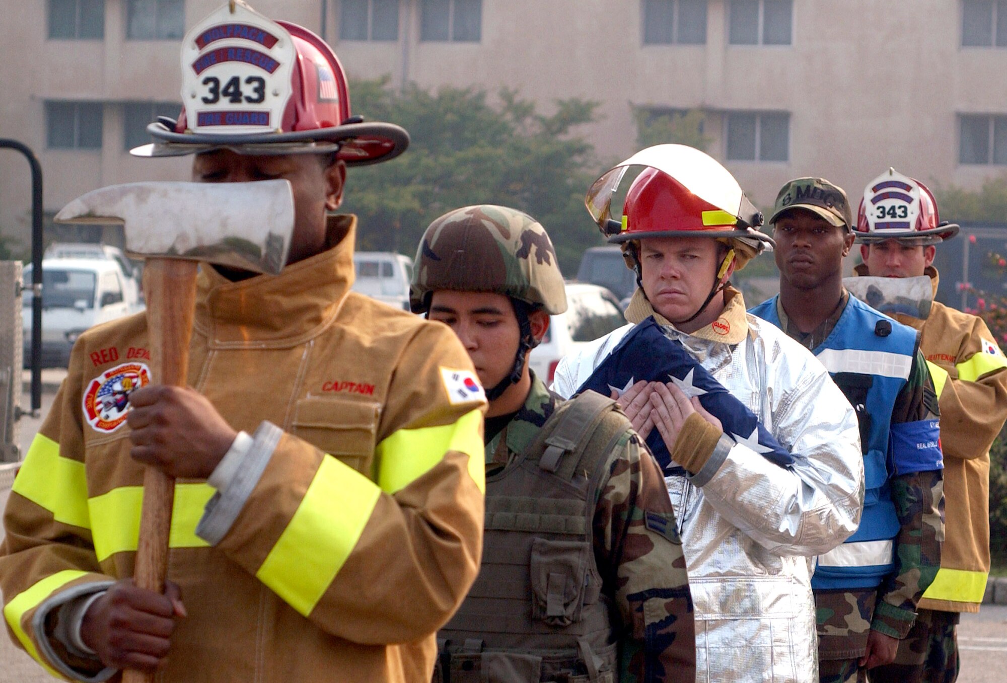 Airmen from the base fire department, 8th Medical Group and 8th Security Forces Squadron form the colors team for the Sept. 11, 2001, remembrance ceremony Sept. 11 at Kunsan Air Base, South Korea. The ceremony marked the sixth anniversary of the terrorist attacks in New York City, the Pentagon and Shanksville, Pa. (U.S. Air Force photo/Senior Airman Steven R. Doty) 
