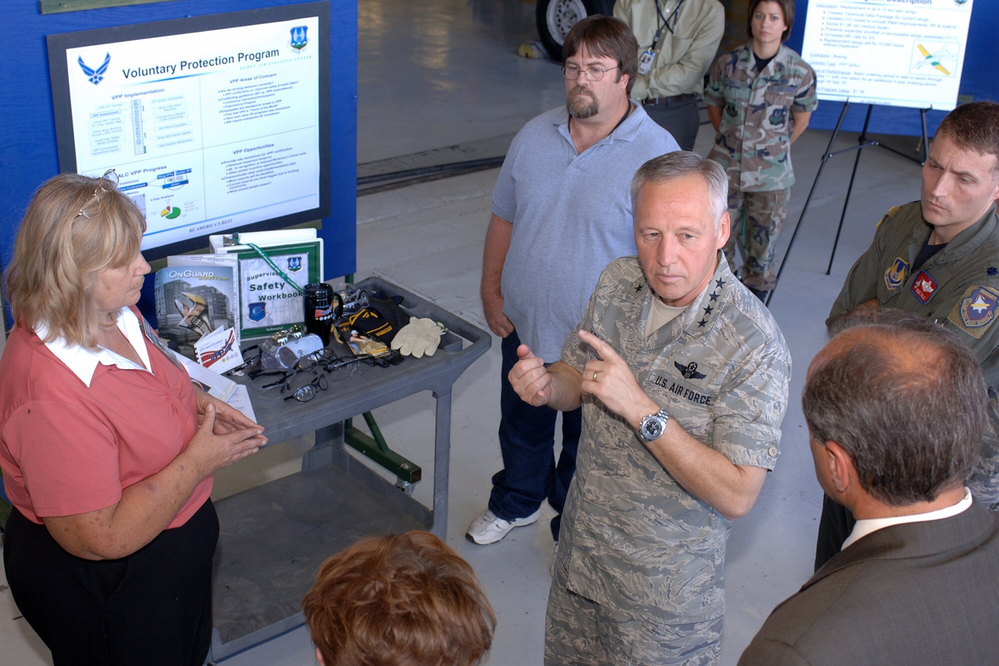 Gen. Bruce Carlson, commander of Air Force Materiel Command, talks to Don Cazel, Ogden Air Logistics Center deputy director, about Hill Air Force Base's Voluntary Protection Program. (U.S. Air Force Photo by Alex R. Lloyd)