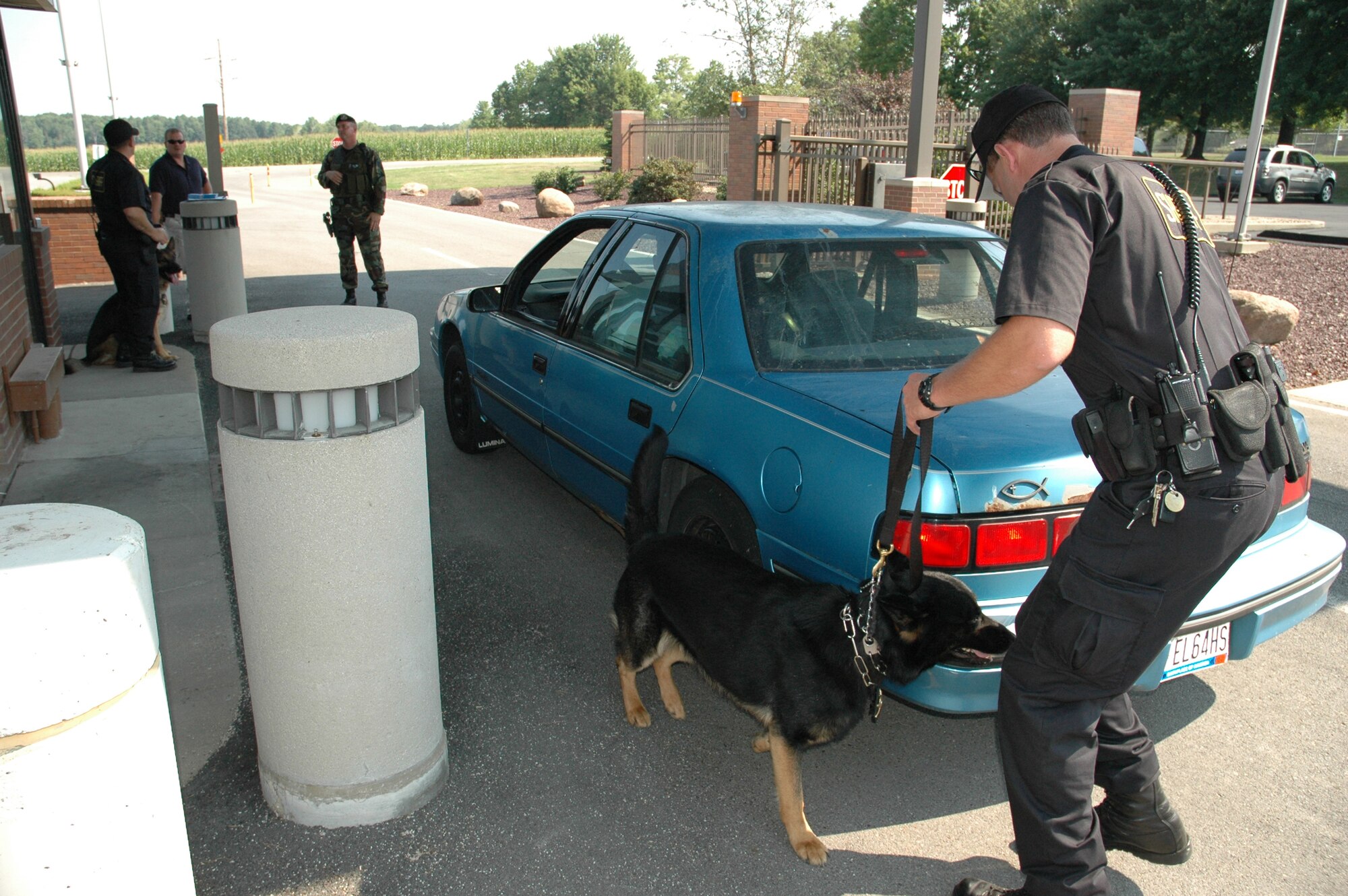 YOUNGSTOWN AIR RESERVE STATION, Ohio — Todd Reichenbach, a K-9 handler with Summit County Sheriff's office, takes his canine "Ammo" around vehicles leaving here to detect explosives or narcotics.  Last month, eight K-9s  were on duty here to perform explosive and narcotics detection.  The intent of the operation was to be proactive and remind personnel as well as the surrounding community that the installation operates under a no tolerance policy.  In addition, the intent was to deter any individual or group that could intend on trying to bring harm to the installation or its personnel.  Air Force OSI  Special Agent Julie McKee organized the joint canine effort with local law enforcement officials and Youngstown Air Reserve Station officials.  Participating agencies include:  Trumbull Co. Sheriff, Summit Co. Sheriff, Warren Police Dept., Ohio State Highway Patrol, and the Air Force Office of Special Investigations based out of Pittsburgh ARS. U.S. Air Force Photo/Capt. Brent J. Davis        