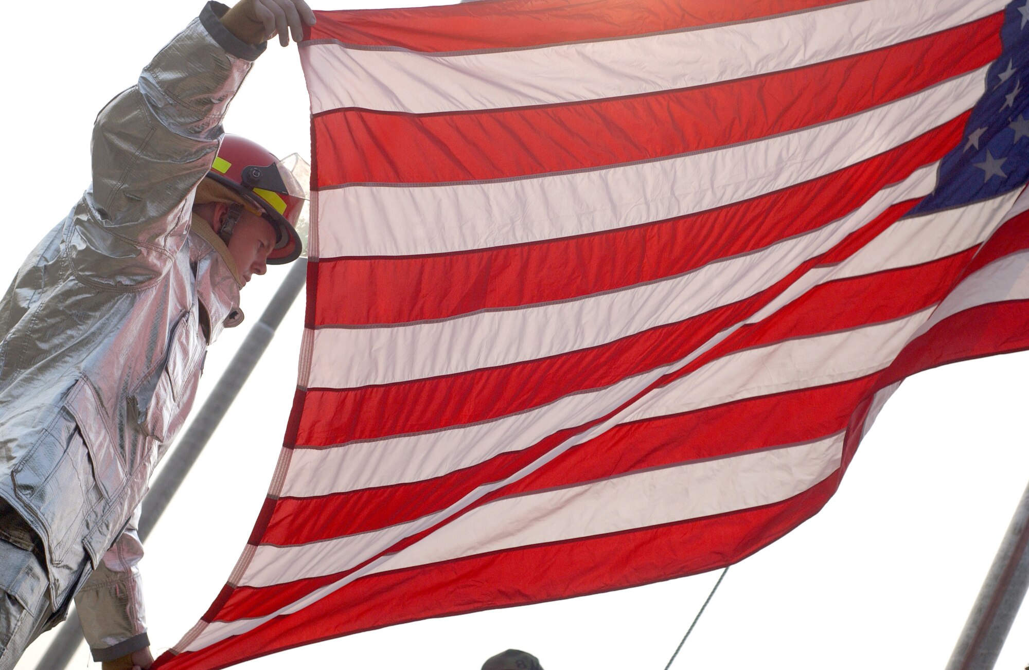 KUNSAN AIR BASE, South Korea – Tech. Sgt. Jason Rosenbaum, a firefighter with the 8th Civil Engineer Squadron, helps raise the flag during the Sept. 11, 2001 remembrance ceremony here Tuesday.  Sergeant Rosenbaum was the project coordinator for the ceremony marking the 6th anniversary of the terrorist attacks in New York City, the Pentagon and Shanksville, Pa. (U.S. Air Force photo/Senior Airman Steven R. Doty)