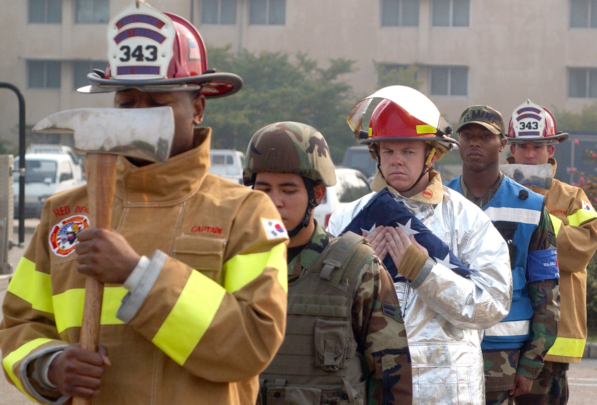 KUNSAN AIR BASE, South Korea -- Airmen from the base fire department, 8th Medical Group and 8th Security Forces Squadron, formed the colors team for the Sept. 11, 2001 remembrance ceremony here Tuesday. The ceremony marked the 6th anniversary of the terrorist attacks in New York City, the Pentagon and Shanksville, Pa. (U.S. Air Force photo/Senior Airman Steven R. Doty)             