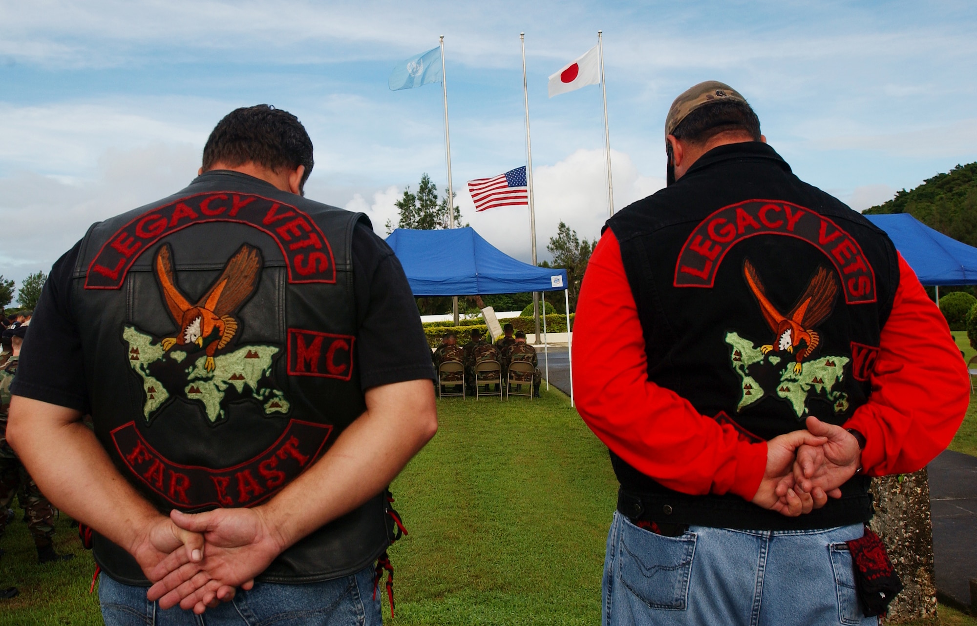 Veterans, Roger Shelton, right, and Kevin Freeland, left, bow their heads during a moment of silence at the 9/11 memorial ceremony at Kadena Air Base, Japan, Sept. 11, 2007.