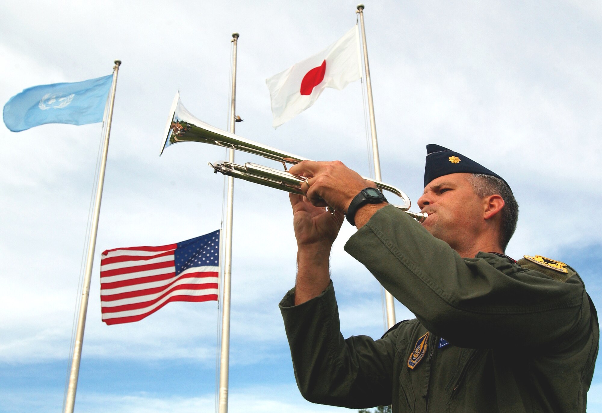 Maj. Jason Settle, 18th Wing Inspector General chief of wing exercises, plays Taps during the 9/11 memorial ceremony on Kadena AB, Japan, Sept. 11, 2007.
(U.S. Air Force photo/Tech. Sgt. Reynaldo Ramon)
