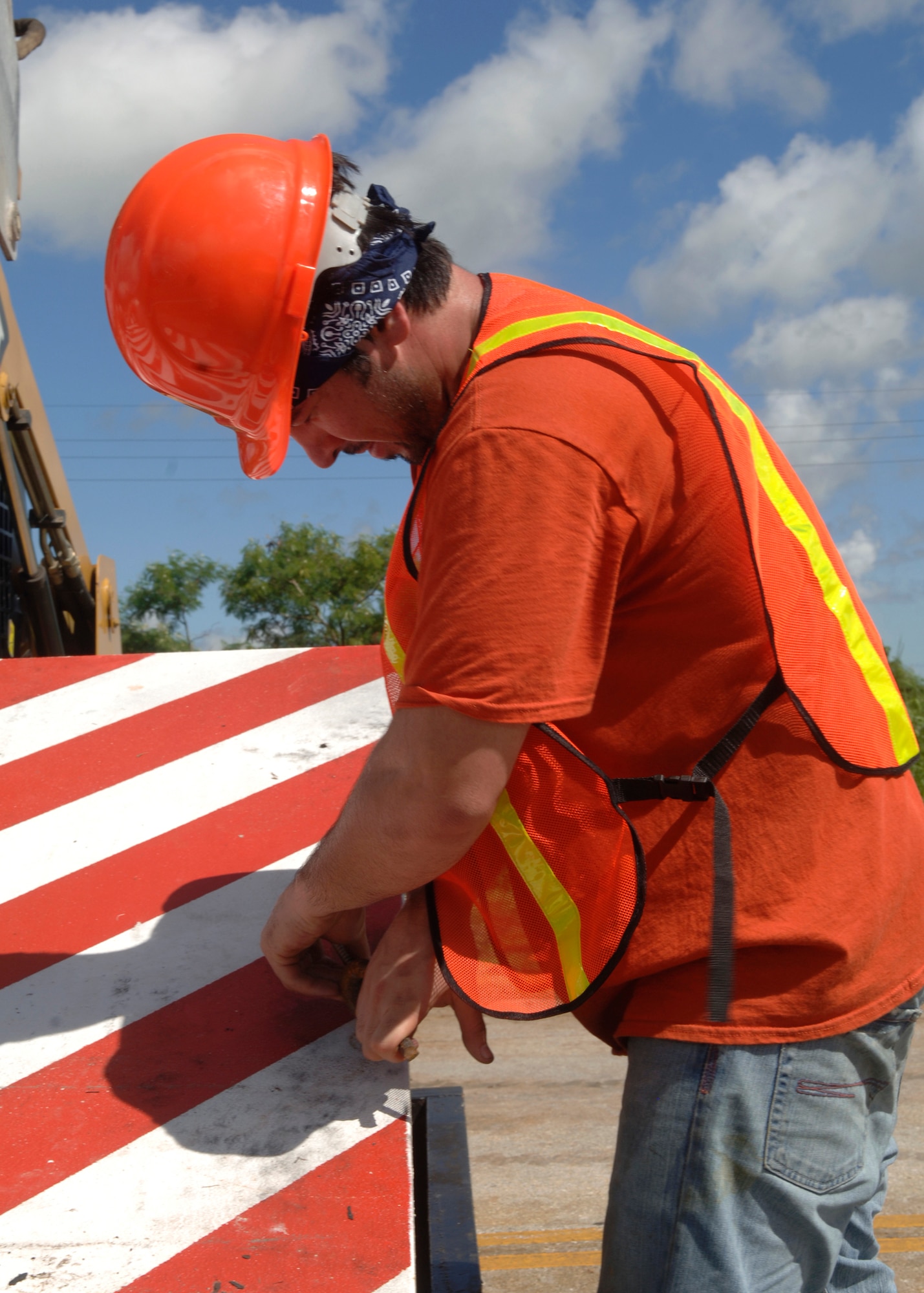 ANDERSEN AFB – Brandt Naito, GSA construction worker, loosens a bolt on a barrier being installed for added security measures here recently. Construction started Aug. 29 with an estimated completion date of Sept.  20. (USAF Photo by Senior Airman Sonya Padilla)