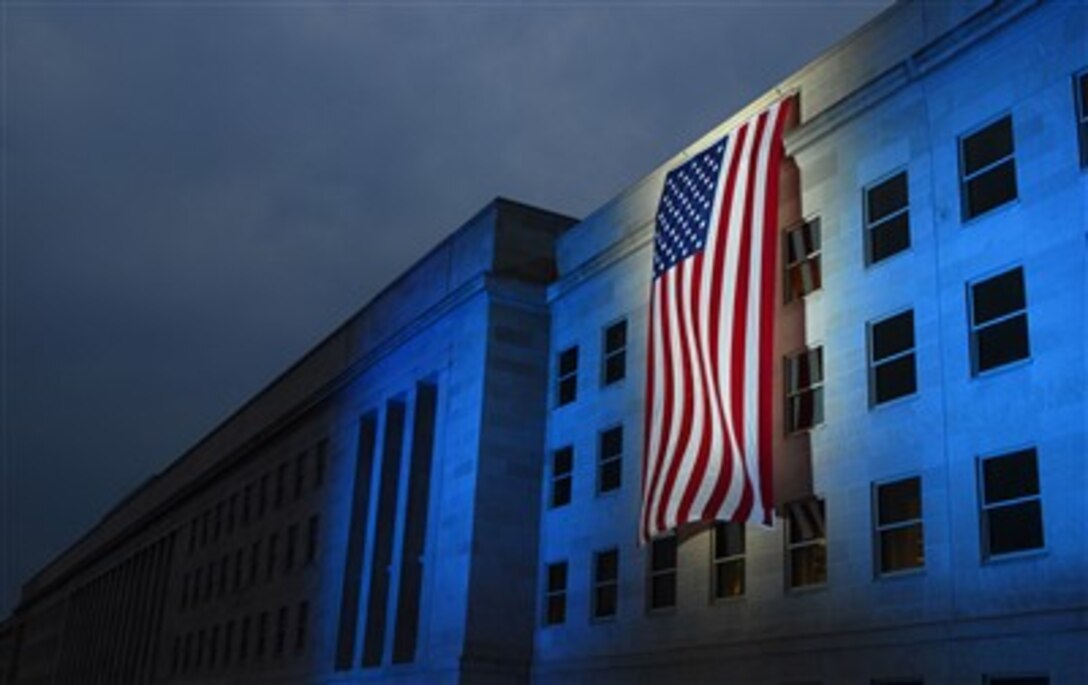 An illuminated American flag is displayed at the Pentagon near the spot where American Airlines Flight 77 crashed into the building on Sept. 11 in preparation for a remembrance and wreath laying ceremony at the Pentagon on Sept. 11, 2007.  Secretary of Defense Robert M. Gates will be joined by Chairman of the Joint Chiefs of Staff Gen. Peter Pace, U.S. Marine Corps, in laying a wreath in memory of the 184 people who lost their lives at the Pentagon in the attack.  