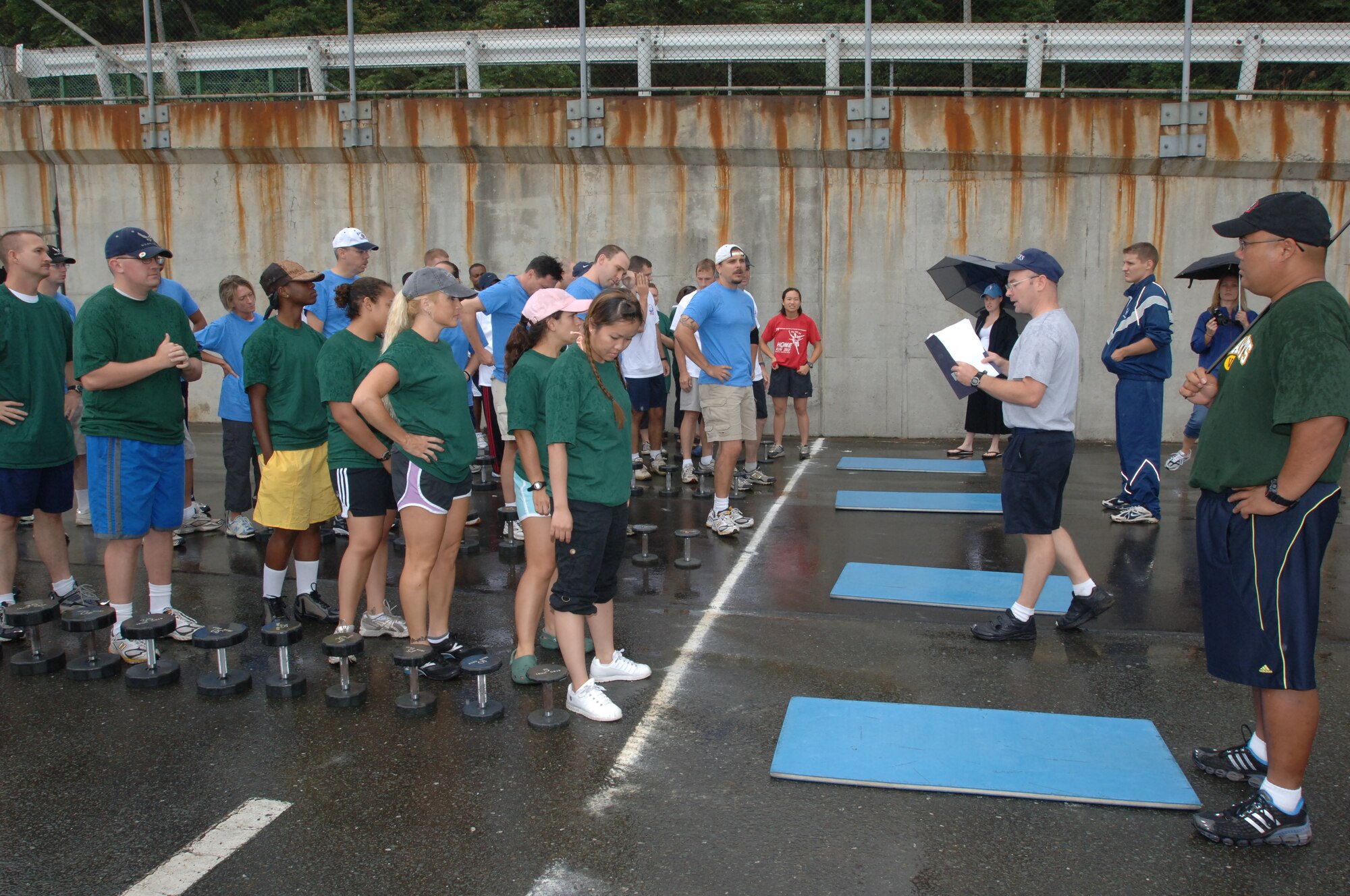 Teams line up and prepare to begin the fitness challenge during the first Survivor Challenge here August 31, 2007. Fourteen teams challenged each other for the first prize of $2,000; however, it was the 35th Communications Squadron team that took the prize. Events consisted of the fitness challenge, bag toss and puzzle, canoe course, water balloon launch, taste of Japan, emperor's challenge, and knowledge challenge. 