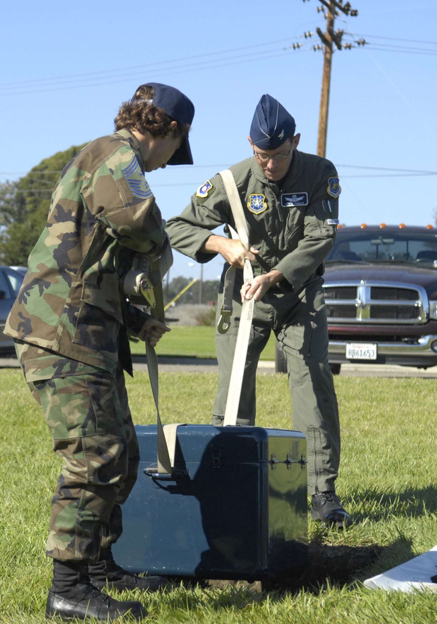 VANDENBERG AIR FORCE BASE, Calif. -- 30th Space Wing Commander Col. Steve Tanous and 30th Space Wing Command Chief Master Sgt. Cari Kent emplace a time capsule in the ground during the emplacement of the time capsule ceremony at Heritage Park Korean War memorial on Sept. 11. The capsule, which commemorates the 25th Anniversary of Air Force Space Command, will be opened in 50 years.  (U.S. Air Force photo/Airman 1st Class Matthew Plew) 
