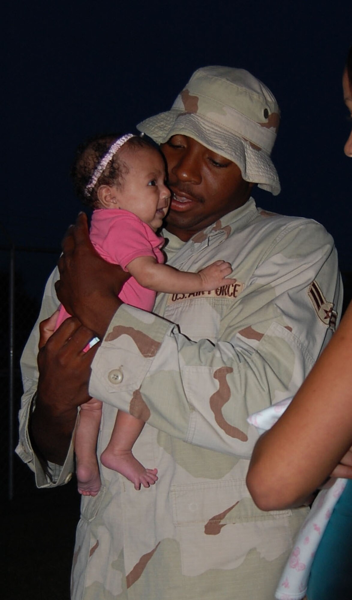 LAUGHLIN AIR FORCE BASE, Texas -- Airman 1st Class holds his six-week-old daughter, Arianna Renee Bailey, for the first time after returning home September 11 from serving his country for six months in Qatar.(U.S. Air Force photo by Airman Sara Csurilla)