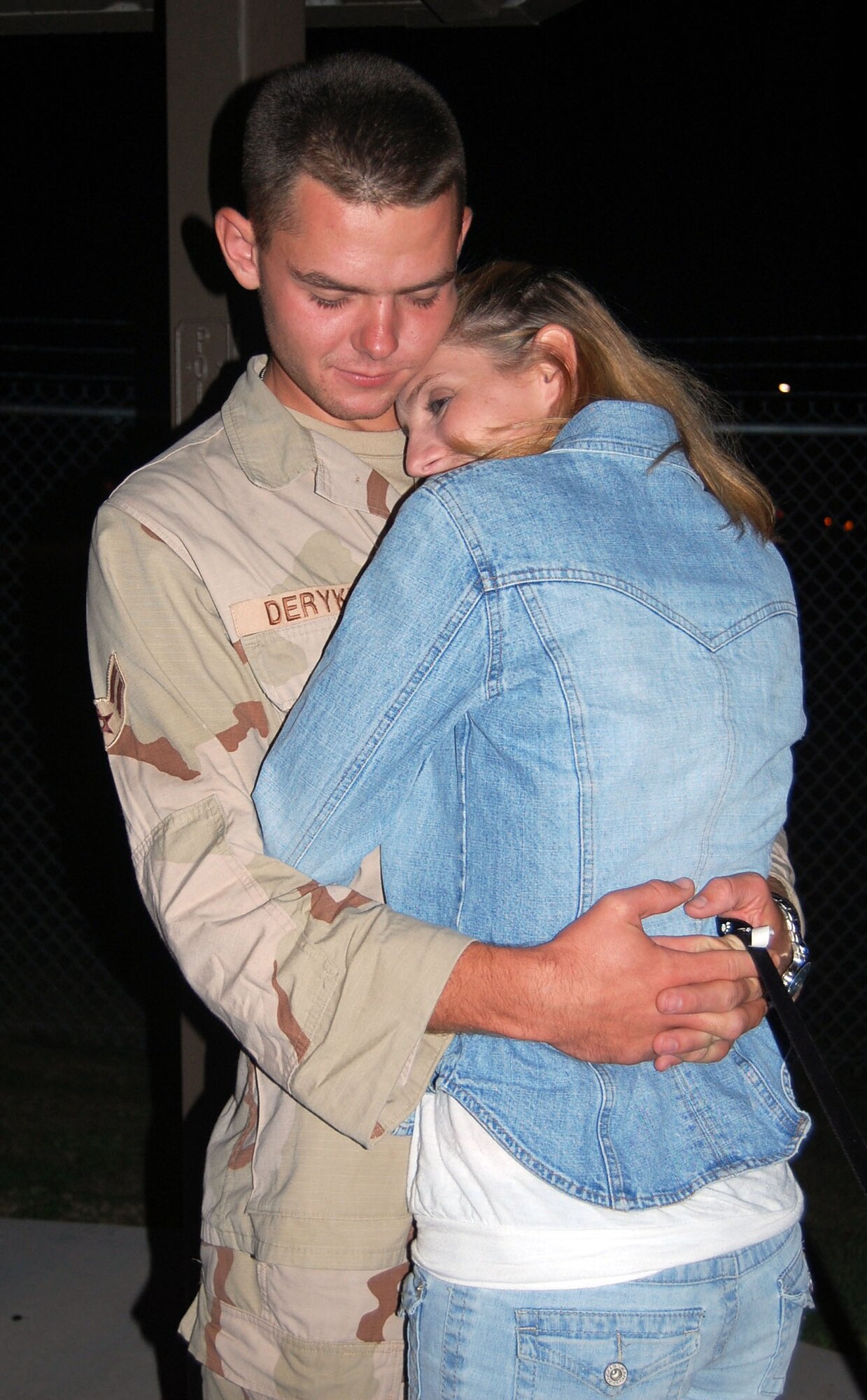 LAUGHLIN AIR FORCE BASE, Texas -- Airman 1st Class Brandon Deryke, 47th Security Forces Squadron holds his girlfriend Airman Rachel Robinson, 47th Contracting Squadron, for the first time in months after his six month deployment to Qatar. (U.S. Air Force photo by Airman Sara Csurilla)