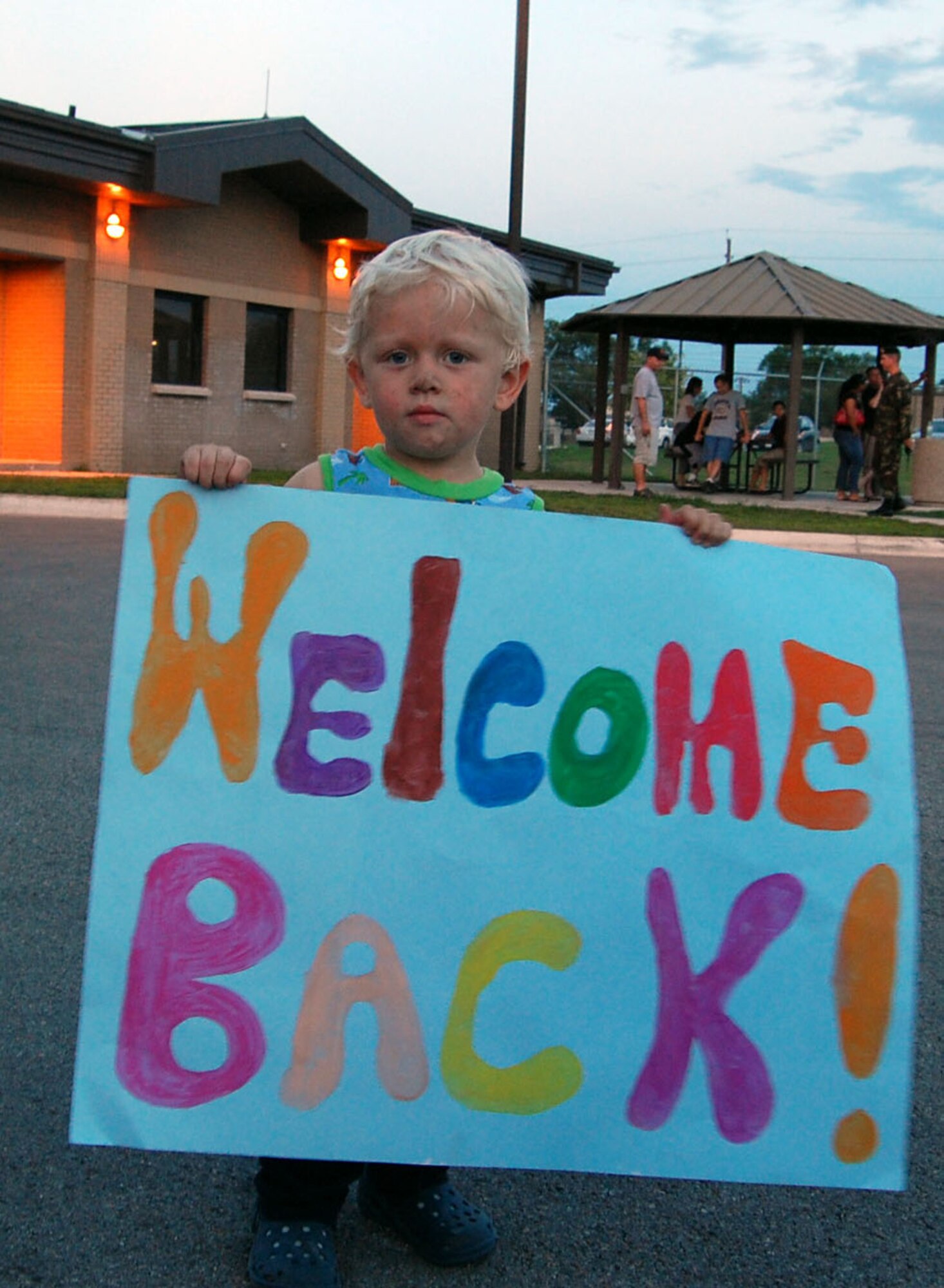 LAUGHLIN AIR FORCE BASE, Texas -- Wil Taylor, son of Staff Sgt. Lenaha Taylor, who works in the 47th Flying Training Wing Staff Judge Advocate office, and Paul Taylor, holds a sign to welcome back the 13 Airman returning home from serving their country in Qatar September 11. (U.S. Air Force photo by Airman Sara Csurilla)
