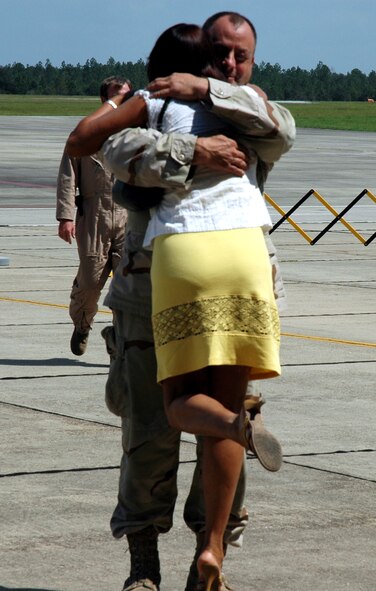 Tech. Sgt. Duane E. Selph, 919th Maintenance Squadron, hugs his wife, Nina upon returning from a 60-day deployment to Southwest Asia. Sergeant Selph was one of 40 Airmen who returned Sept. 7. (U.S. Air Force Photo\Jasmine DeNamur) 