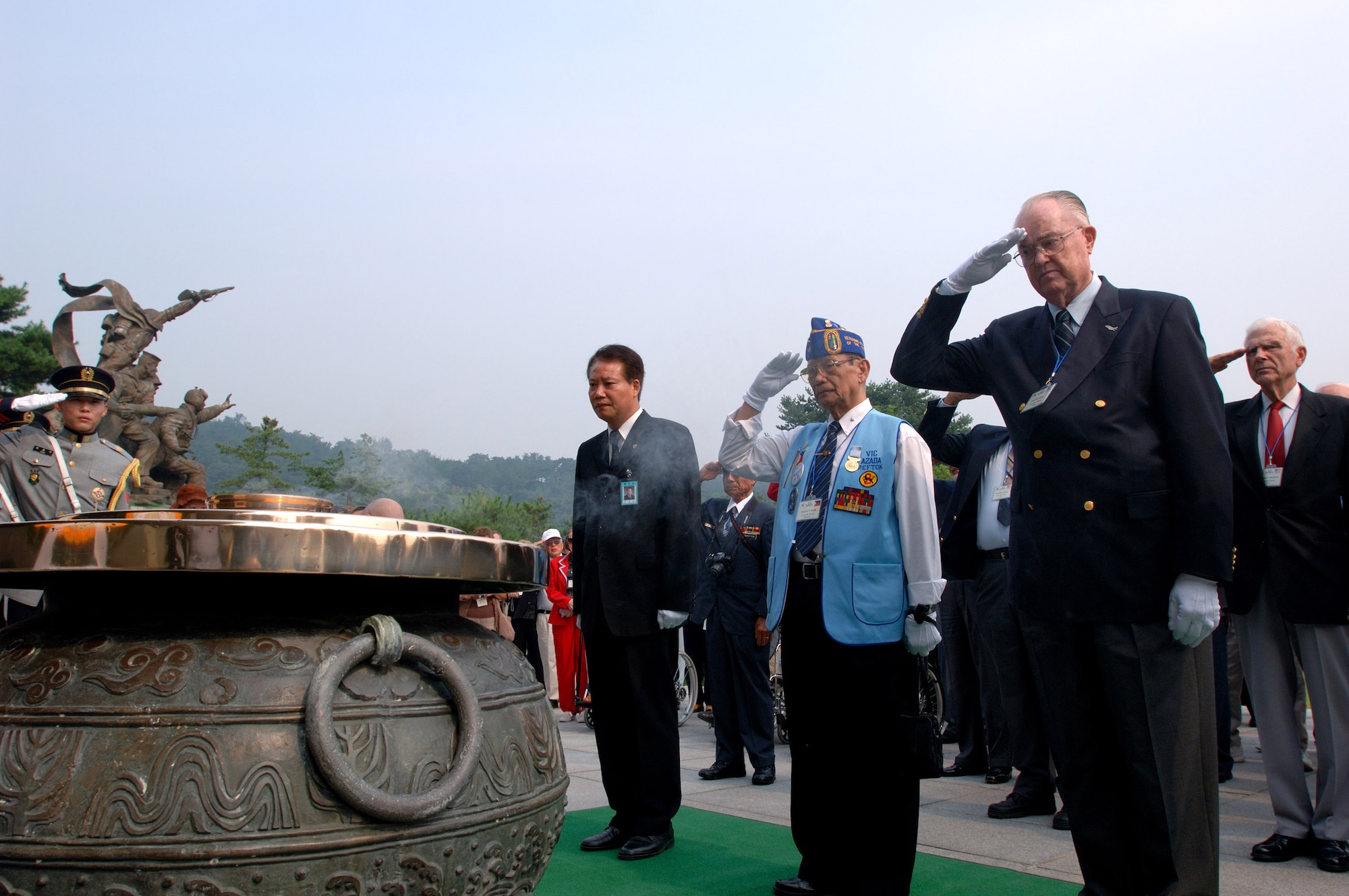Retired Maj. Gen. Carl G. Schneider (right) and retired Philippines Gen. Vic Azada (Center) salute to honor the lost men and women of the Korean War after a wreath-laying ceremony at the South Korean National Cemetery attended by more than 200 war veterans and family members Sept. 12. The South Korean government's Revisit Korea program invites war veterans each year to come to South Korea to honor the men and woman from 21 countries who served during the Korean War. Nearly 25,000 veterans have participated in this program since 1975. (U.S. Air Force photo/Staff Sgt. Bennie J. Davis III)