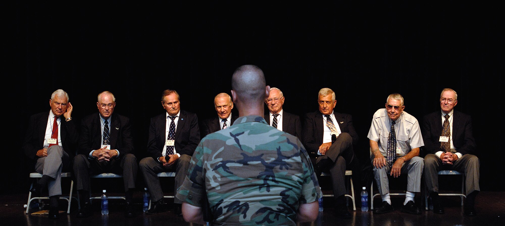 Retired Air Force members Lt. Gen. Charles G. Cleveland (from left), Maj. Gen. Carl G. Schneider, Col. Ralph Gibson, Col. Buzz Aldrin, Col. Pete Carpenter, Col. Ken Shealy, Col. Harold Fischer and Col. Robert Moxley, answer questions during an Air Force Call with nearly 150 Airmen from Yongsan Army Garrison, South Korea. (U.S. Air Force photo/Staff Sgt. Bennie J. Davis III) 
