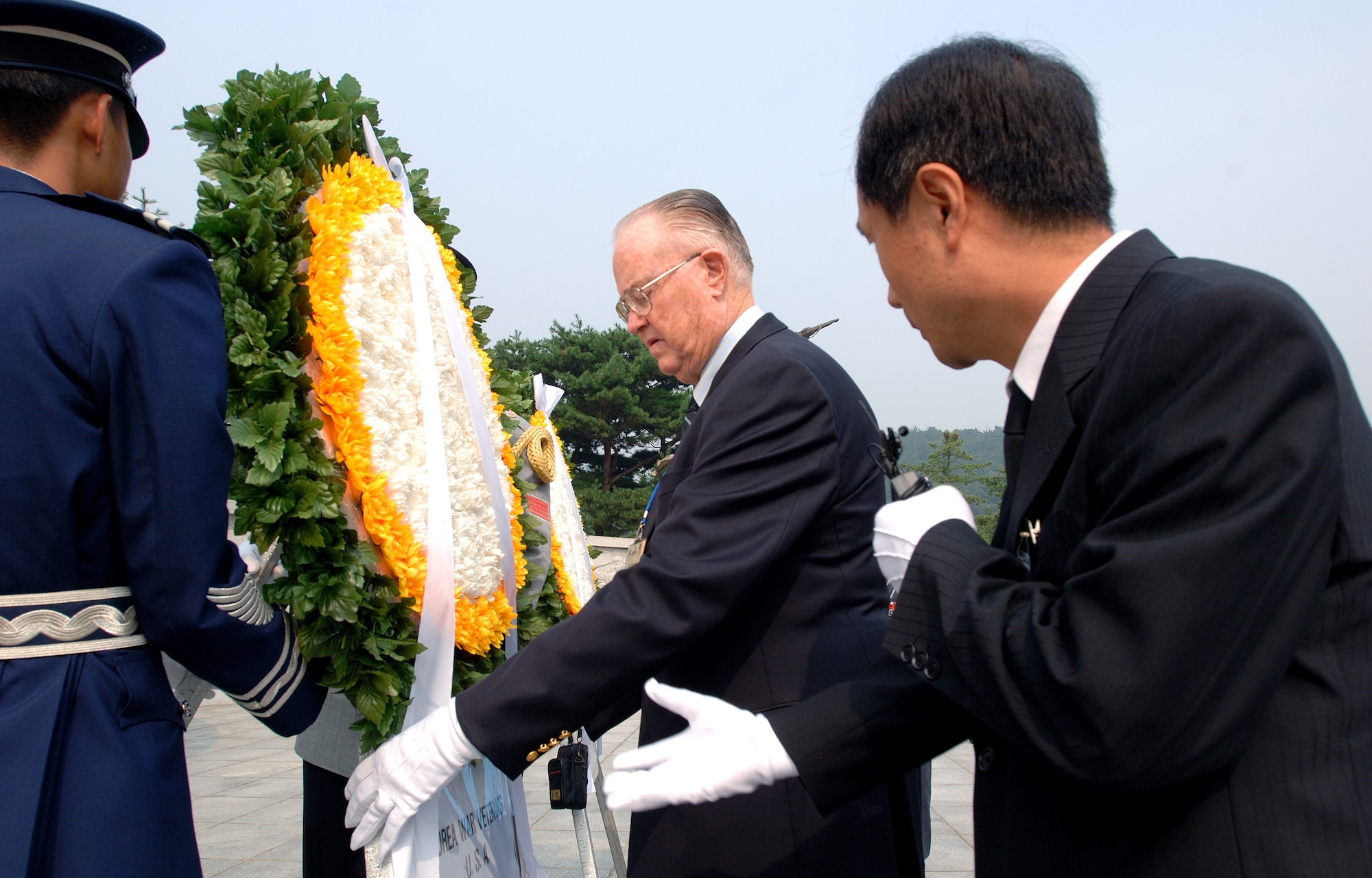 Retired Maj. Gen. Carl G. Schneider places a wreath before a Korean War Monument during a ceremony at the South Korean National Cemetery along with fellow Korean War veterans Sept. 12. The South Korean government's Revisit Korea program invites war veterans each year to come to South Korea to honor the men and woman from 21 countries who served during the Korean War. Nearly 25,000 veterans have participated in this program since 1975. (U.S. Air Force photo/Staff Sgt. Bennie J. Davis III) 
