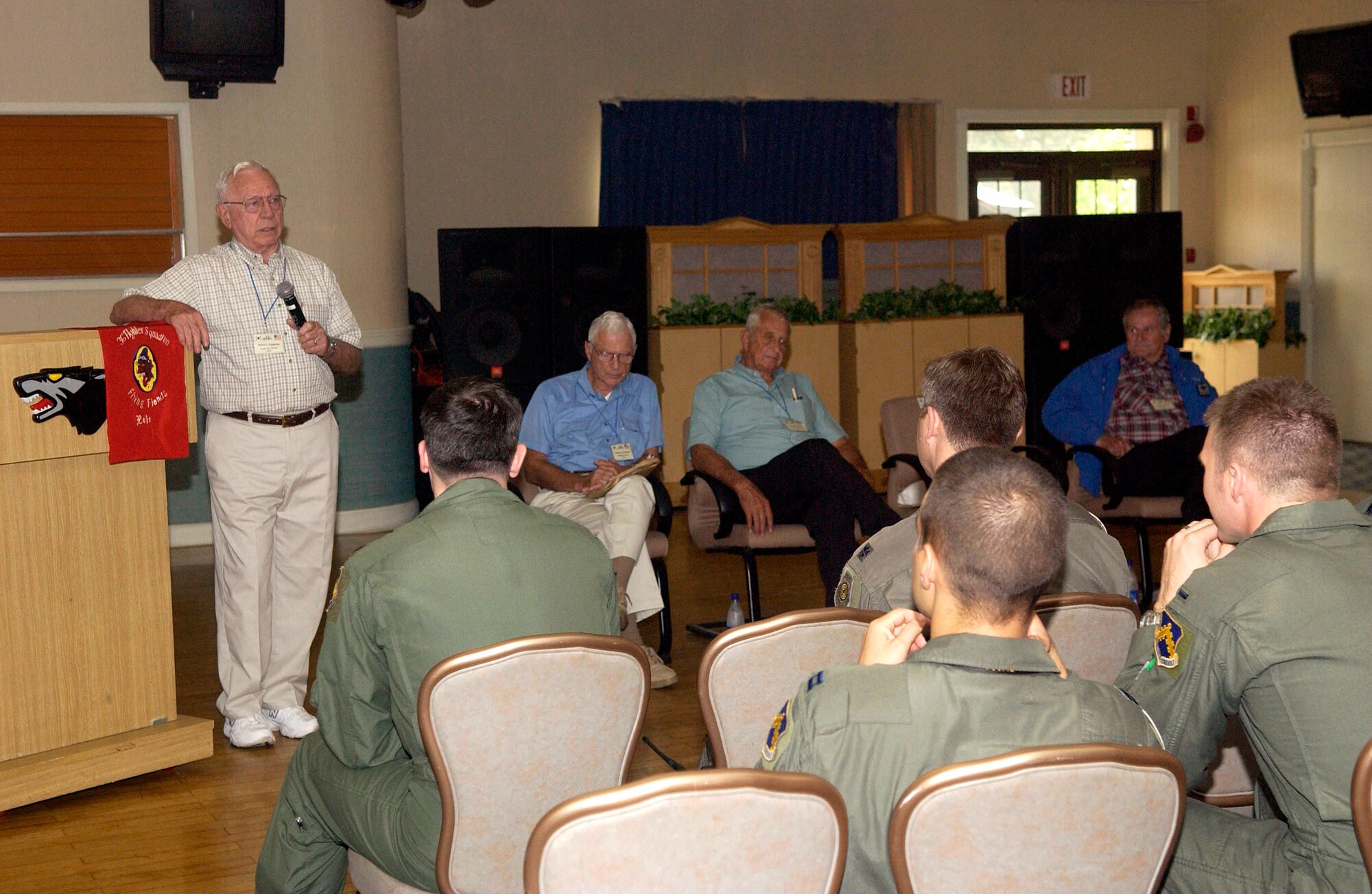 Retired Col. Wilbur Carpenter speaks to 8th Fighter Wing Airmen Sept. 11 about his flying experiences during the Korean War as Lt. Gen. Charles Cleveland, Col. Kenneth Shealy and Col. Ralph Gibson await their opportunity to speak.  The four veterans were visiting Kunsan and sharing their experiences with the Airmen there.  (U.S. Air Force photo/Senior Airman Giang Nguyen)