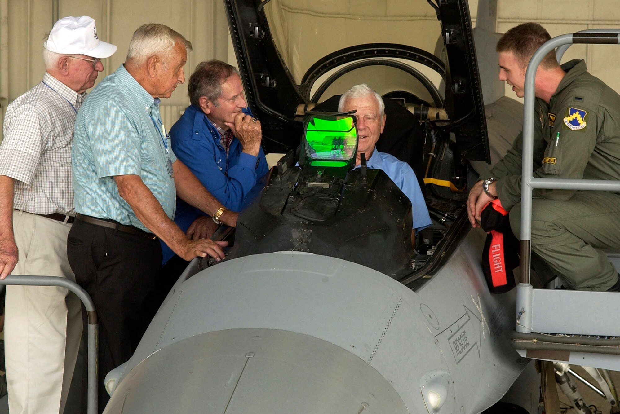 Capt. Cesar Orozco shows retired Lt. Gen. Charles Cleveland the functions of the F-16 Fighting Falcon Sept. 11 as Cols. Wilbur Carpenter (left to right), Kenneth Shealy and Ralph Gibson observe.  The four Korean War veterans were visiting Kunsan Air Base, South Korea, and sharing their experiences with 8th Fighter Wing Airmen.  Captain Orozco is with the 35th Fighter Squadron.  (U.S. Air Force photo/Senior Airman Giang Nguyen)