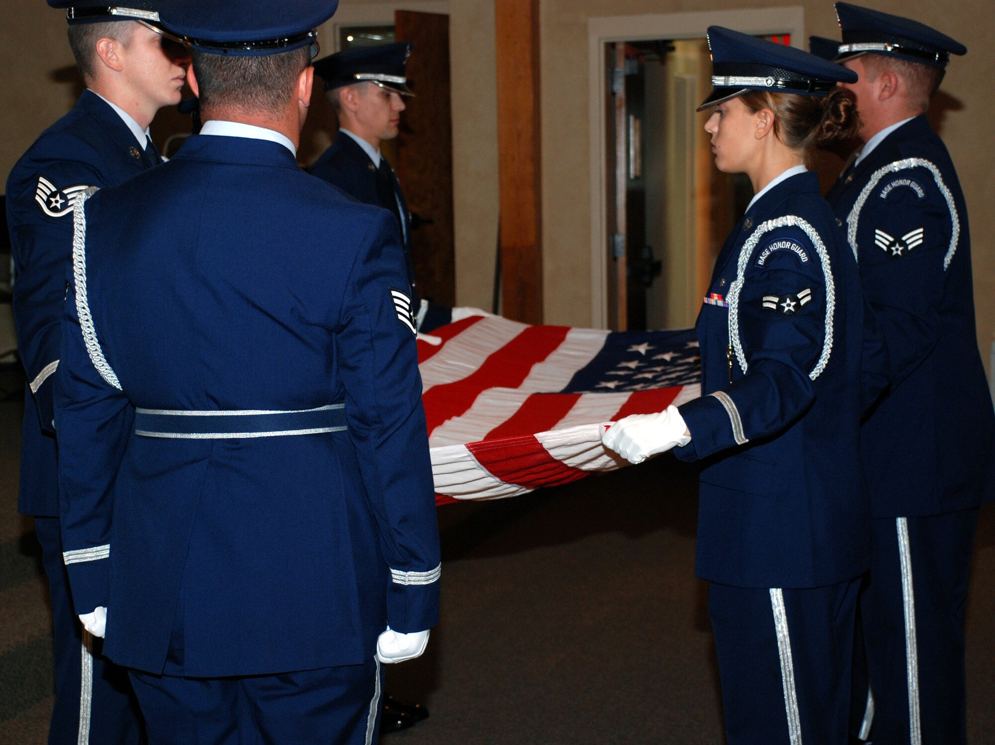 Sheppard Honor Guard members perform a flag folding ceremony Sept. 11 at the North Chapel during a memorial service for the victims of the terror attacks on Sept. 11, 2007. Retired Air Force Col. Kathleen Roberts, the guest speaker for the event, spoke of her duties at the Pentagon in the days following the attacks. (U.S. Air Force photo/John Ingle)
