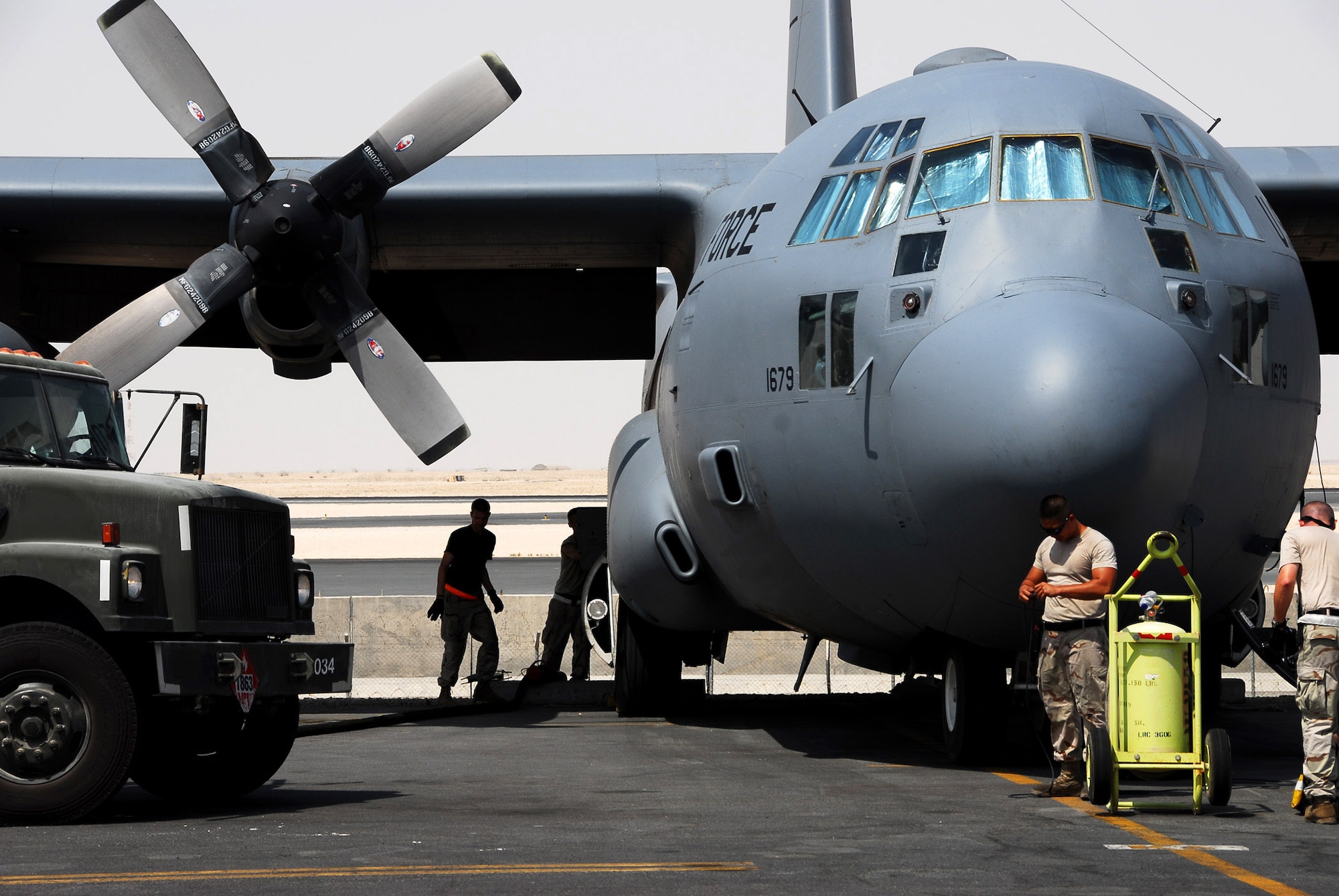 Air Force maintainers prepare a C-130 Hercules for an airlift mission at a base in Southwest Asia.  On Sept. 11, approximately 160 airlift sorties were flown, 430 tons of cargo were delivered and nearly 4,775 passengers were transported.  (U.S. Air Force photo/Tech. Sgt. Scott Moorman)