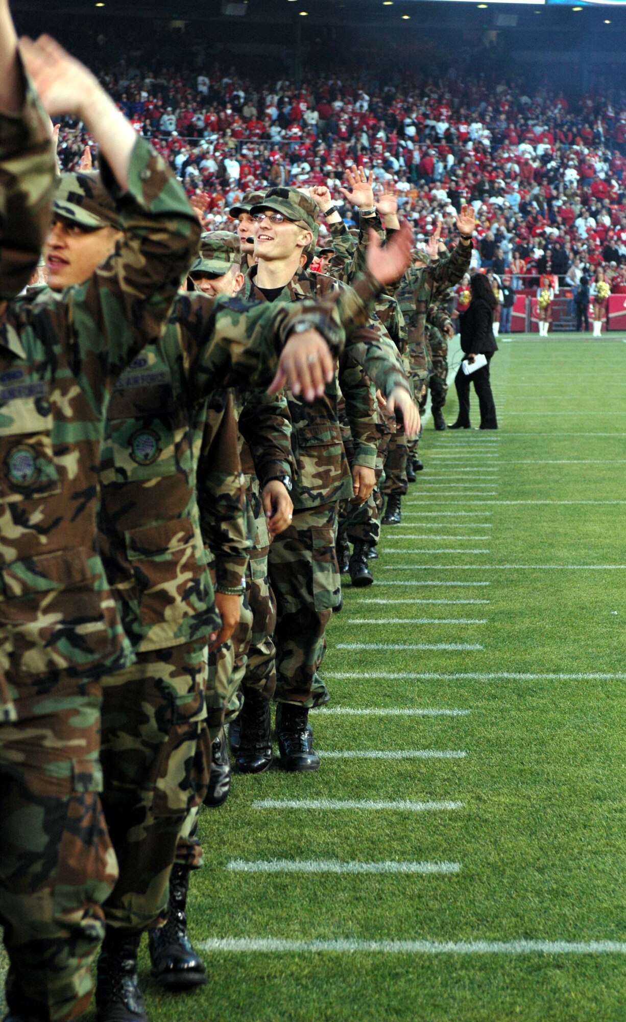 Travis Airmen wave to the crowd during the San Francisco 49ers/Arizona Cardinals pre-game ceremony Sept. 10 at Monster Park Stadium, San Francisco. Travis Airmen are regularly invited to present the colors at professional sporting events in the Bay Area. (U.S. Air Force photo/Tech. Sgt. Donald Osborn)

