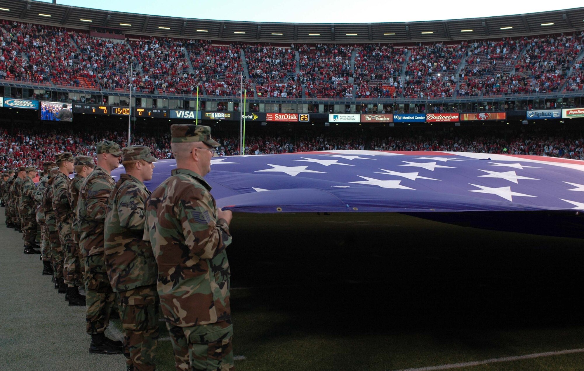 Travis Airmen unfold the American flag during the San Francisco 49ers/Arizona Cardinals pre-game ceremony Sept. 10 at Monster Park Stadium, San Francisco. The 49ers defeated the Cardinals 20-17 during the Monday night game. (U.S. Air Force photo/Tech. Sgt. Donald Osborn)