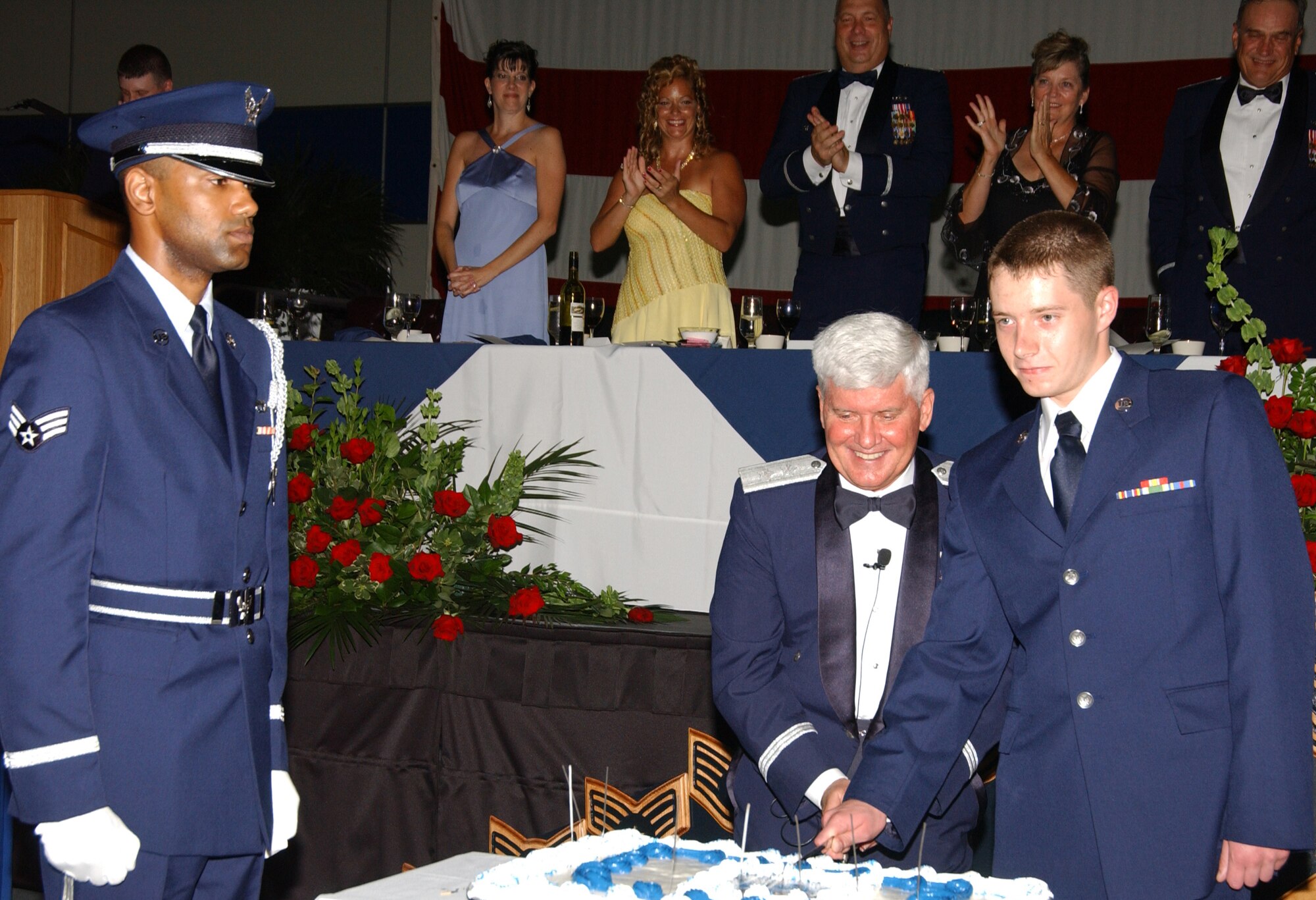 Maj. Gen. Allan R. Poulin, Air Force Reserve Command vice commander, and Airman Basic Greg A. Harper, 439th Aircraft Maintenance Squadron, cut the cake at Westover's 60th Anniversary of the Air Force military ball Sept. 8.                               
