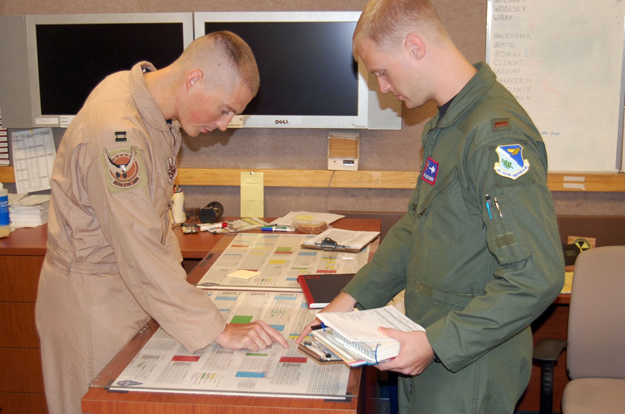 Laughlin Air Force Base, Texas – Capt. Joe Goldsworthy, 87th Flying Training Squadron’s N Flight commander, discusses upcoming sorties with 2nd Lt. Scott Meskimen, a student pilot in the 87th FTS. Hundreds of Laughlin Airmen wore desert uniforms on Sept. 11 to mark the significance of the day and the service and sacrifice they and their deployed brethren have and are making. Capt. Goldsworthy served two tours at Bagram AB, Afghanistan, as an A-10 Thunderbolt pilot. The “Warthog,” as the A-10 is affectionately known to the ground forces it supports so well, is one of the premier close air support aircraft in the U.S. arsenal. (U.S. Air Force Photo/Tech. Sgt. Joel Langton)  