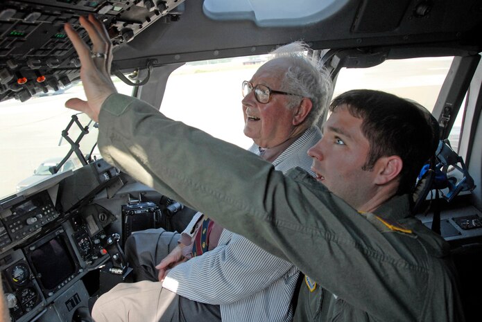 Capt. Jeremy Kahoe, 17th Airlift Squadron pilot, shows Doctor Dan Fenn Jr., lecturer for the South Carolina Executive Institute, the flight deck of a C-17 during his visit to the base Sept. 6. (U.S. Air Force photo/Senior Airman Sam Hymas)