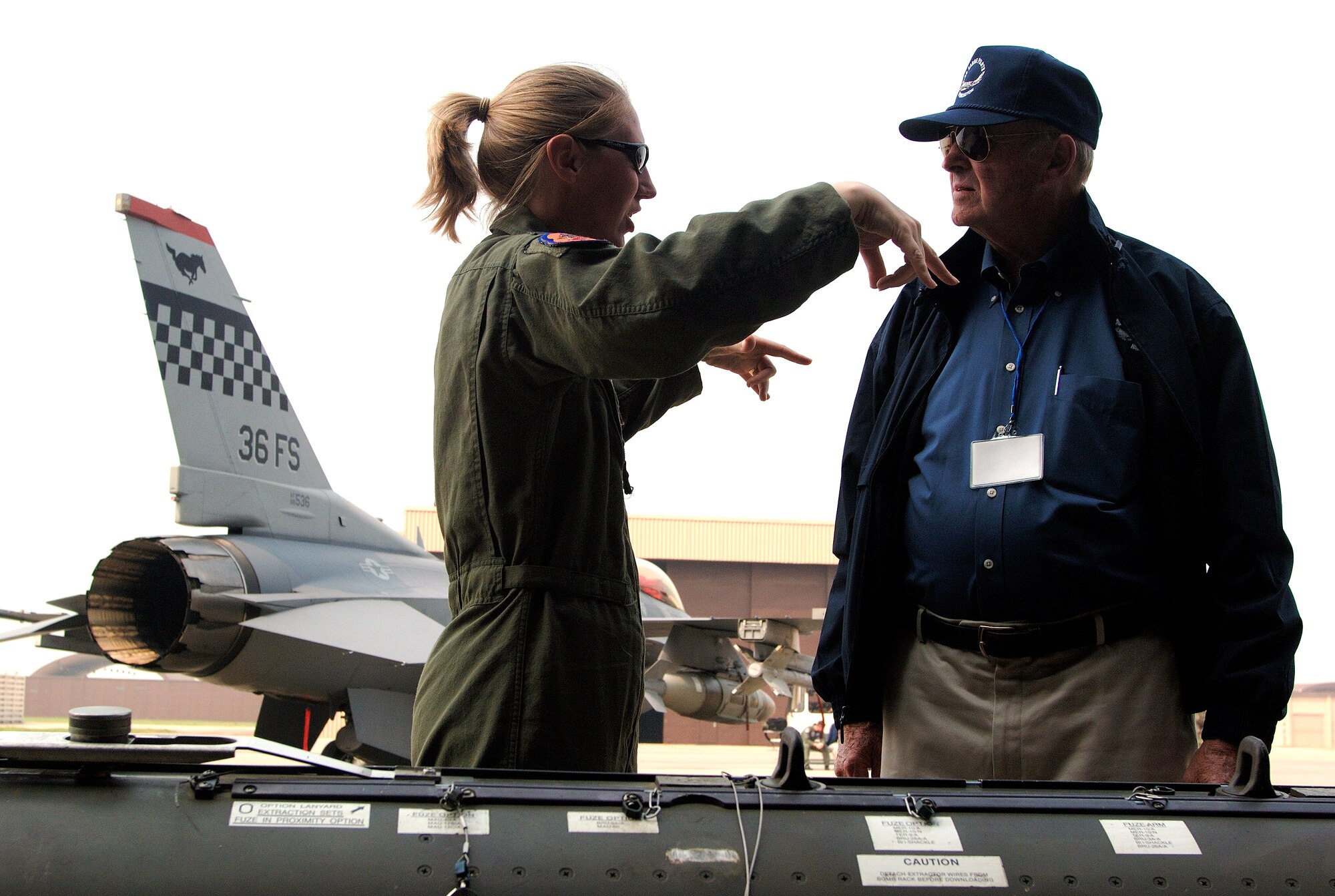 Capt. Katie Gateke briefs Robert Moxley about guided bomb unit-24/27 munition during a Sept. 11 tour of Osan Air Base, South Korea. Mr. Moxley is a visiting Korean War veteran. Korean War veterans are visiting South Korea during a week-long tour in observance of the the Air Force's 60th Anniversary. Captain Gateke is assigned to the 36th Fighter Squadron at Osan AB. (U.S. Air Force photo/Staff Sgt. Bennie J. Davis III)
