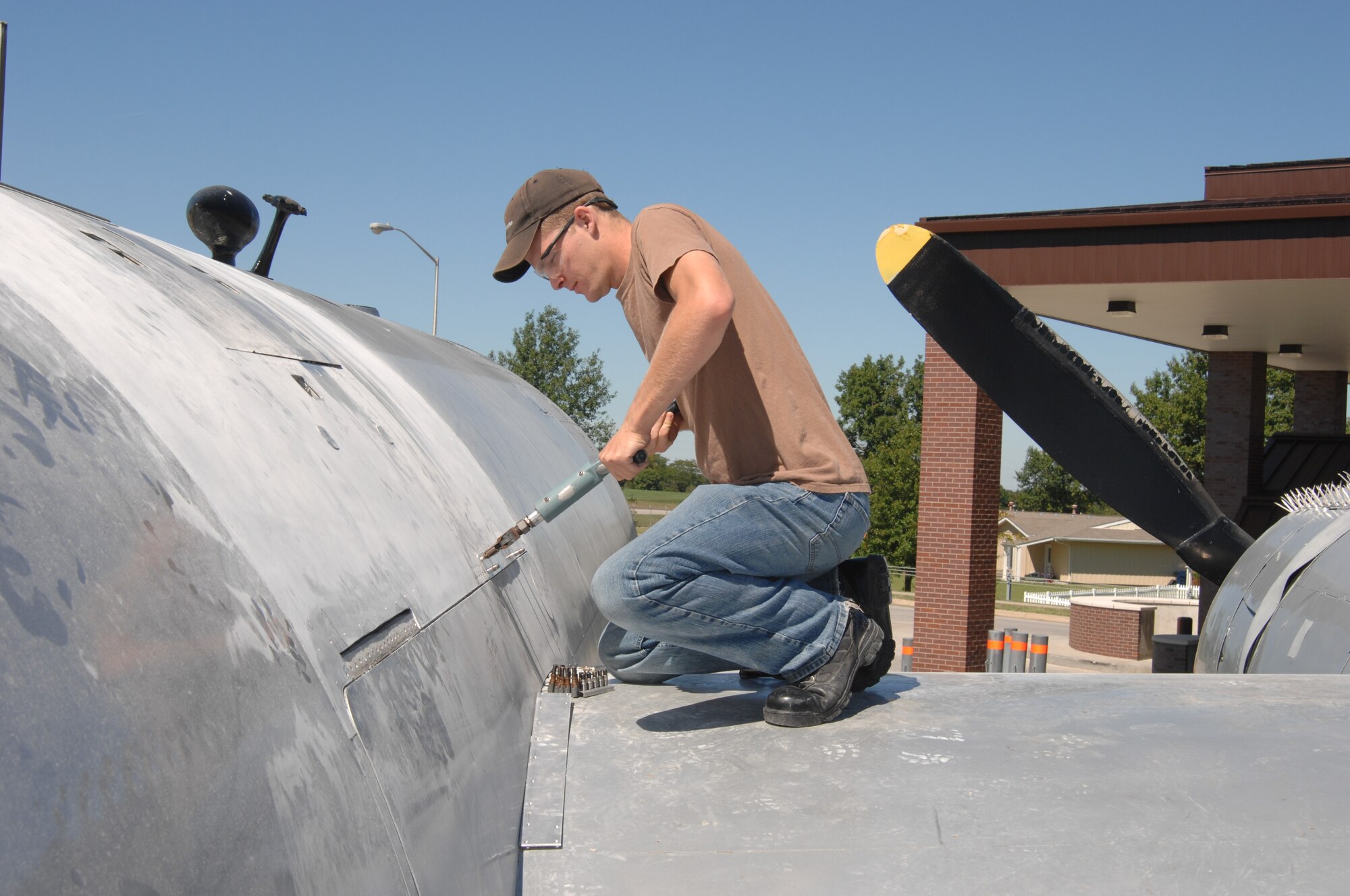 WHITEMAN AIR FORCE BASE, Mo. --  Airman 1st Class Shawn Latshaw, 509th Maintenance Squadron, rivets a scab patch to the fuselage above the right wing of a B-29 bomber Sept.11.  (U.S. Air Force photo/Tech. Sgt. Samuel A. Park)