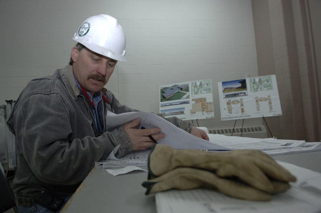 Civilian contractor Ron Crecelius reviews the Air Force Financial Services Center site layout plan in April as changes begin to accommodate the new mission and manning at Ellsworth Air Force Base, S.D. The center will consolidate financial services from 93 bases into a single location, employing up to 775 civilian and military personnel making AFFSC at Ellsworth the financial hub of the Air Force. (U. S. Air Force photo/Staff Sgt. Michael B. Keller)