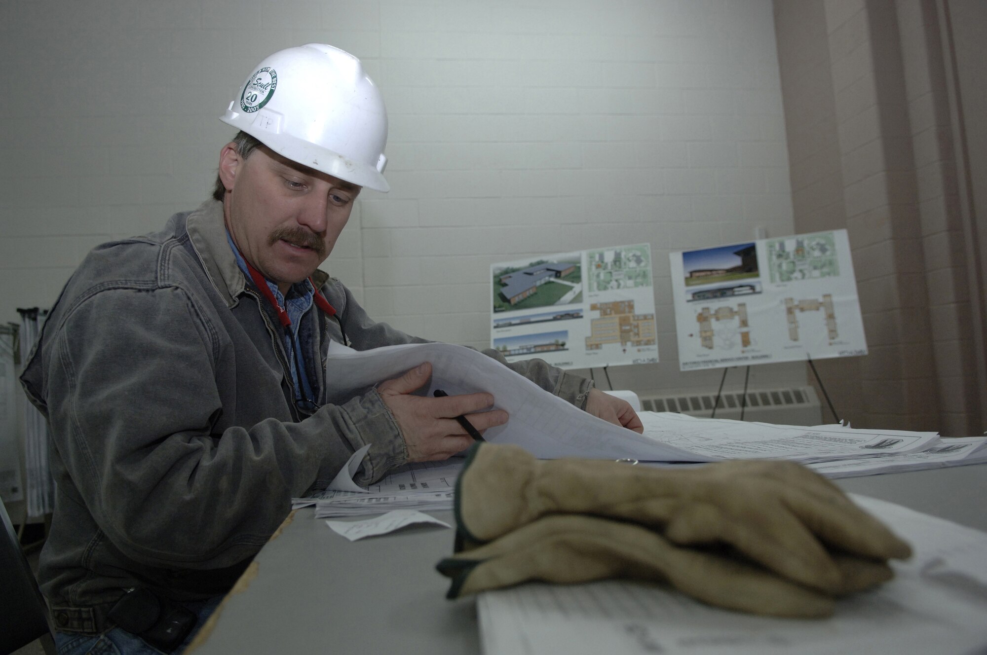 Civilian contractor Ron Crecelius reviews the Air Force Financial Services Center site layout plan in April as changes begin to accommodate the new mission and manning at Ellsworth Air Force Base, S.D. The center will consolidate financial services from 93 bases into a single location, employing up to 775 civilian and military personnel making AFFSC at Ellsworth the financial hub of the Air Force. (U. S. Air Force photo/Staff Sgt. Michael B. Keller)