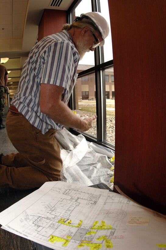 Larry Pettigrew, civilian contractor at Ellsworth Air Force Base, S.D., prepares to install window coverings in April during the final finishes of the future Air Force Financial Services Center. The AFFSC will consolidate financial services from 93 bases into a single location, employing up to 775 people making Ellsworth the financial hub of the Air Force.  (U.S. Air Force photo/Airman 1st Class Erica Rebardi)