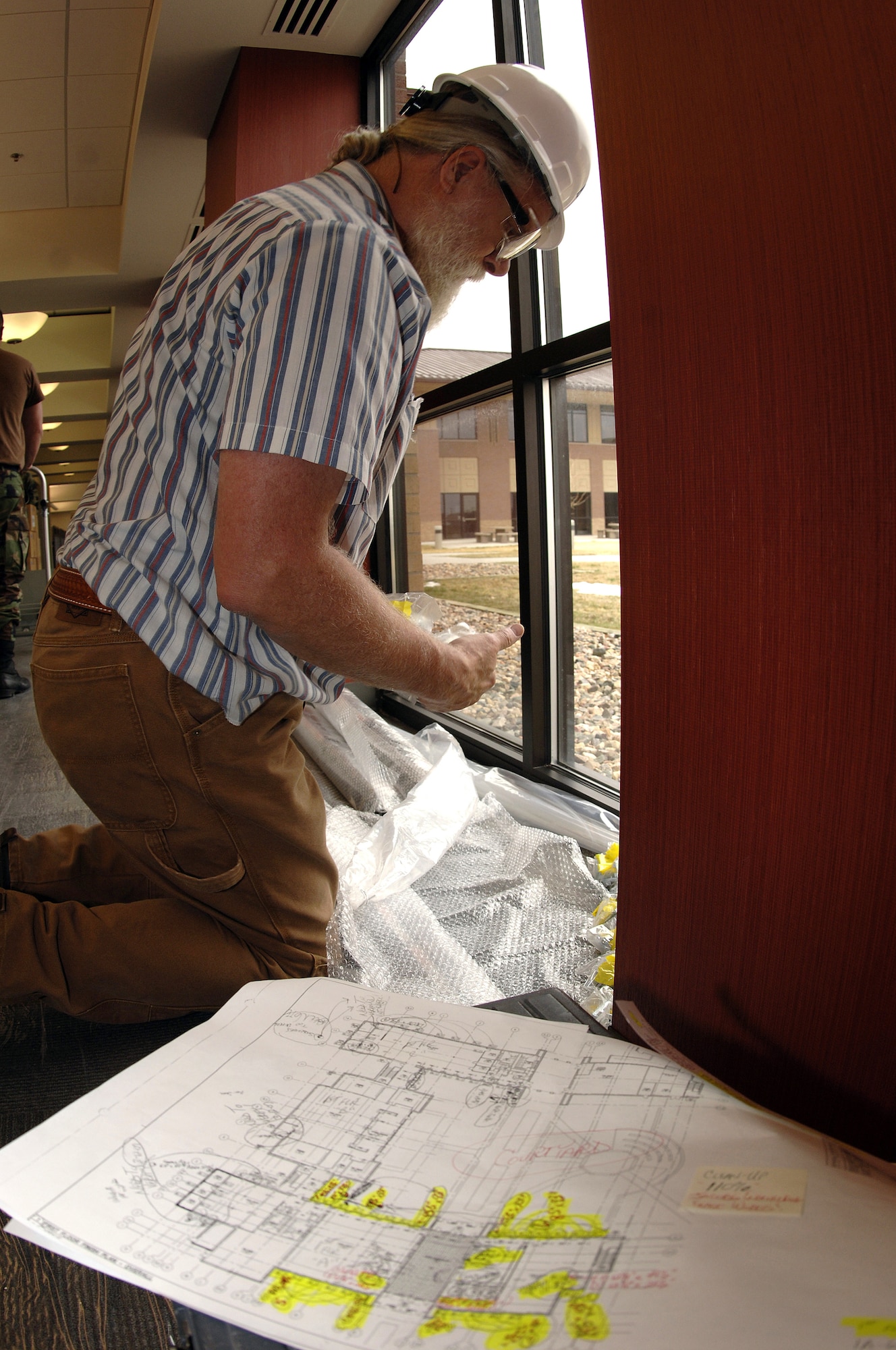 Larry Pettigrew, civilian contractor at Ellsworth Air Force Base, S.D., prepares to install window coverings in April during the final finishes of the future Air Force Financial Services Center. The AFFSC will consolidate financial services from 93 bases into a single location, employing up to 775 people making Ellsworth the financial hub of the Air Force.  (U.S. Air Force photo/Airman 1st Class Erica Rebardi)