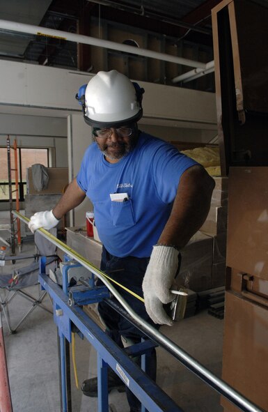 Anthony Maddox, civilian contractor at Ellsworth Air Force Base, S.D., prepares to install voltage duplex outlets April 2 during the construction of the new Air Force Financial Services Center. The AFFSC will consolidate financial services from 93 bases into a single location, employing up to 775 civilian and military personnel, making the AFFSC at Ellsworth the financial hub of the Air Force. (U.S. Air Force Photo/Airman 1st Class Erica Rebardi)