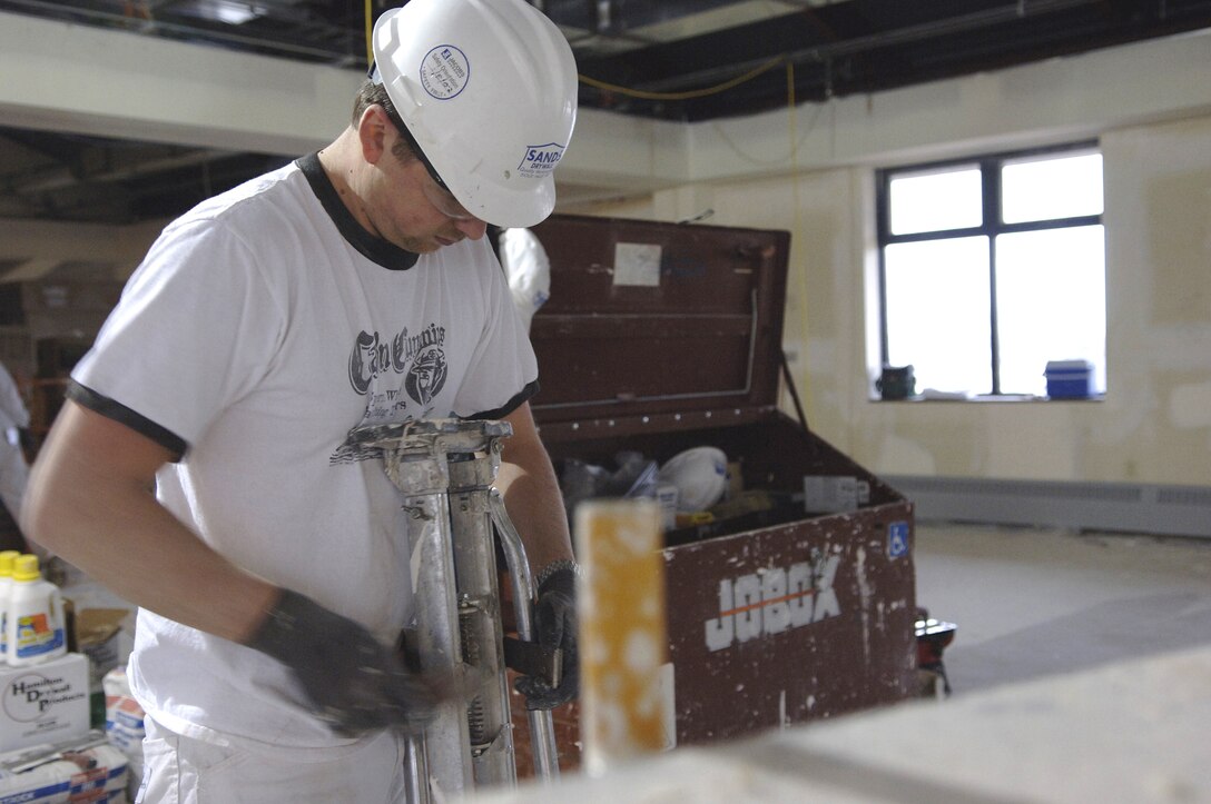 Terry Curl, civilian contractor at Ellsworth Air Force Base, S.D., mixes drywall April 2 during the construction of the new Air Force Financial Services Center. The AFFSC will consolidate financial services from 93 bases into a single location, employing up to 775 civilian and military personnel, making the AFFSC at Ellsworth the financial hub of the Air Force. (U.S. Air Force Photo by/Airman 1st Class Erica Rebardi)