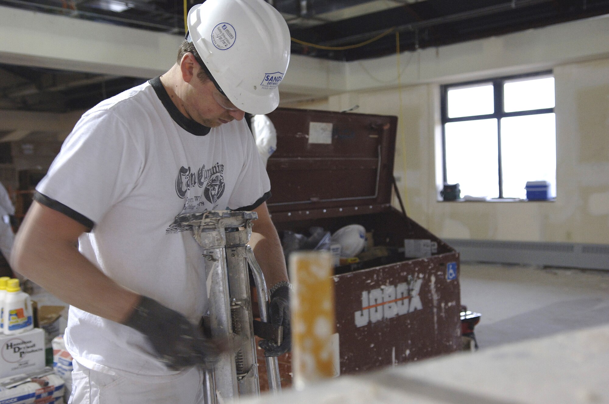 Terry Curl, civilian contractor at Ellsworth Air Force Base, S.D., mixes drywall April 2 during the construction of the new Air Force Financial Services Center. The AFFSC will consolidate financial services from 93 bases into a single location, employing up to 775 civilian and military personnel, making the AFFSC at Ellsworth the financial hub of the Air Force. (U.S. Air Force Photo by/Airman 1st Class Erica Rebardi)
