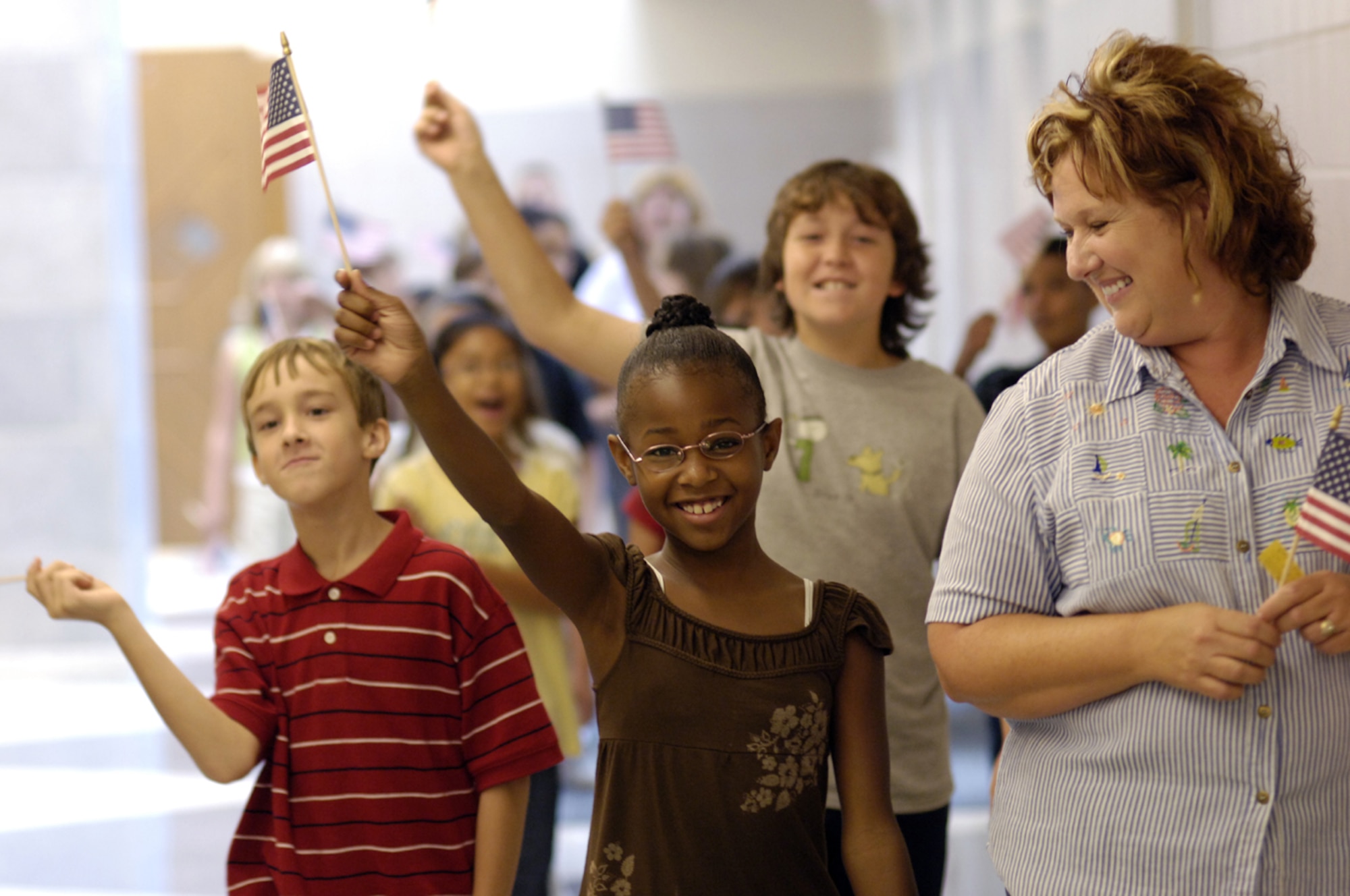 Students from the Upper Elementary School in North Hanover march through the hallways to commemorate the sixth anniversary of the 9/11 terrorist attacks. The students took part in the America Supports You Freedom Walk to show their support for the troops at McGuire Air Force Base, N.J. Military family members make up the majority of the school district's students. (U.S. Air Force photo/Kenn Mann)