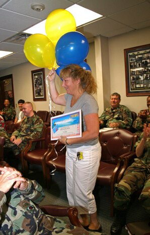 Senior Master Sgt. Samantha Stevens, 315th Aircraft Maintenance Squadron plans and programs manager, is surprised when she finds out she is a MatchUP grand prize winner of a Carnival cruise and $1,000 Sept. 7 in building 59. (U.S. Air Force photo/Salle Jones)