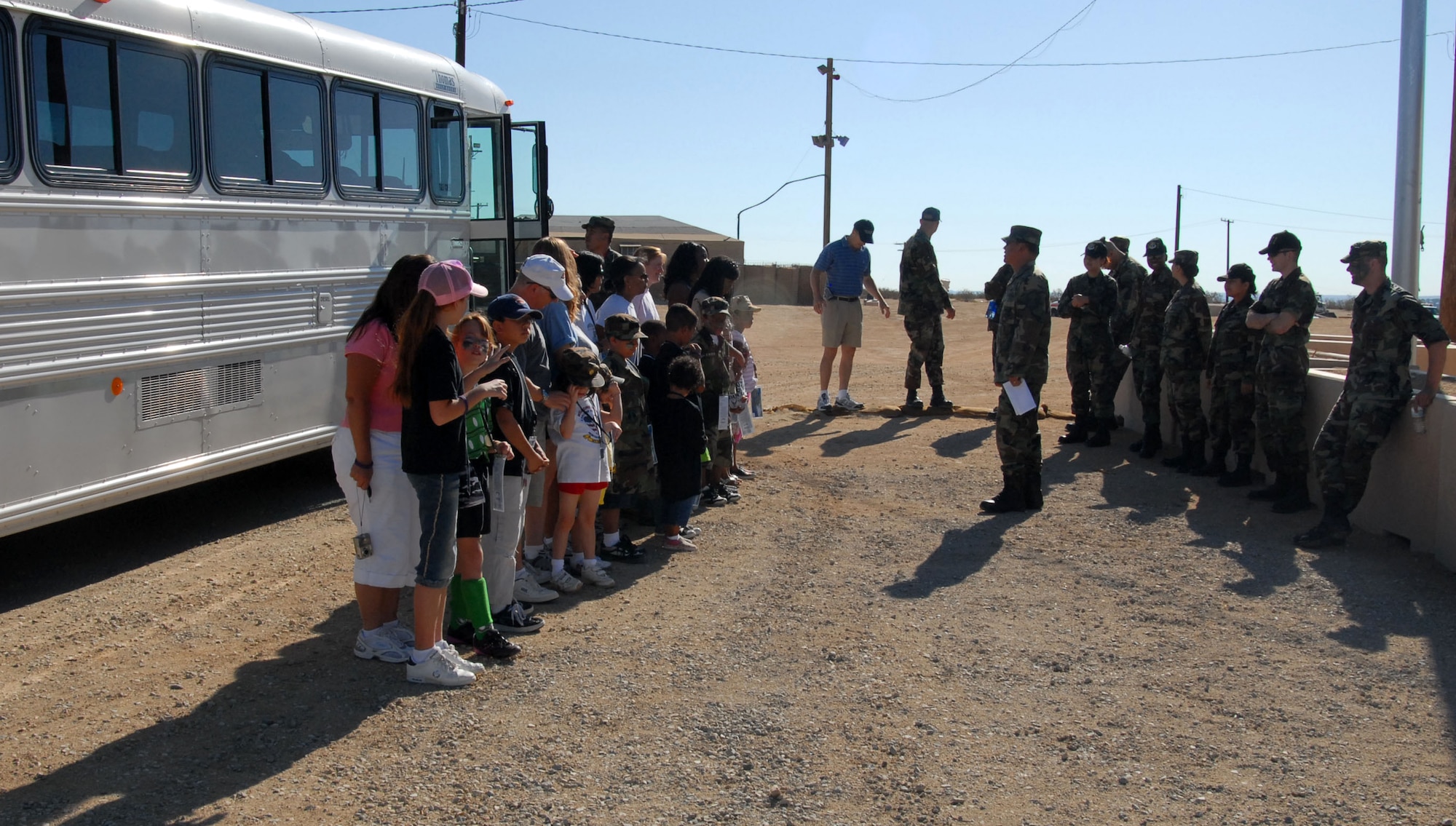 Master Sgt. Jerry Delarosa, Airman and Family Readiness Center superintendent, gives a welcome briefing to children as they arrive at Camp Corum during Operation KUDOS Saturday. Operation KUDOS -- Kids Understanding Deployment Operations -- is designed for children ages 5 to 18 to help give them an understanding of their parent's deployment experiences. (Photo by Airman 1st Class Mike Young)