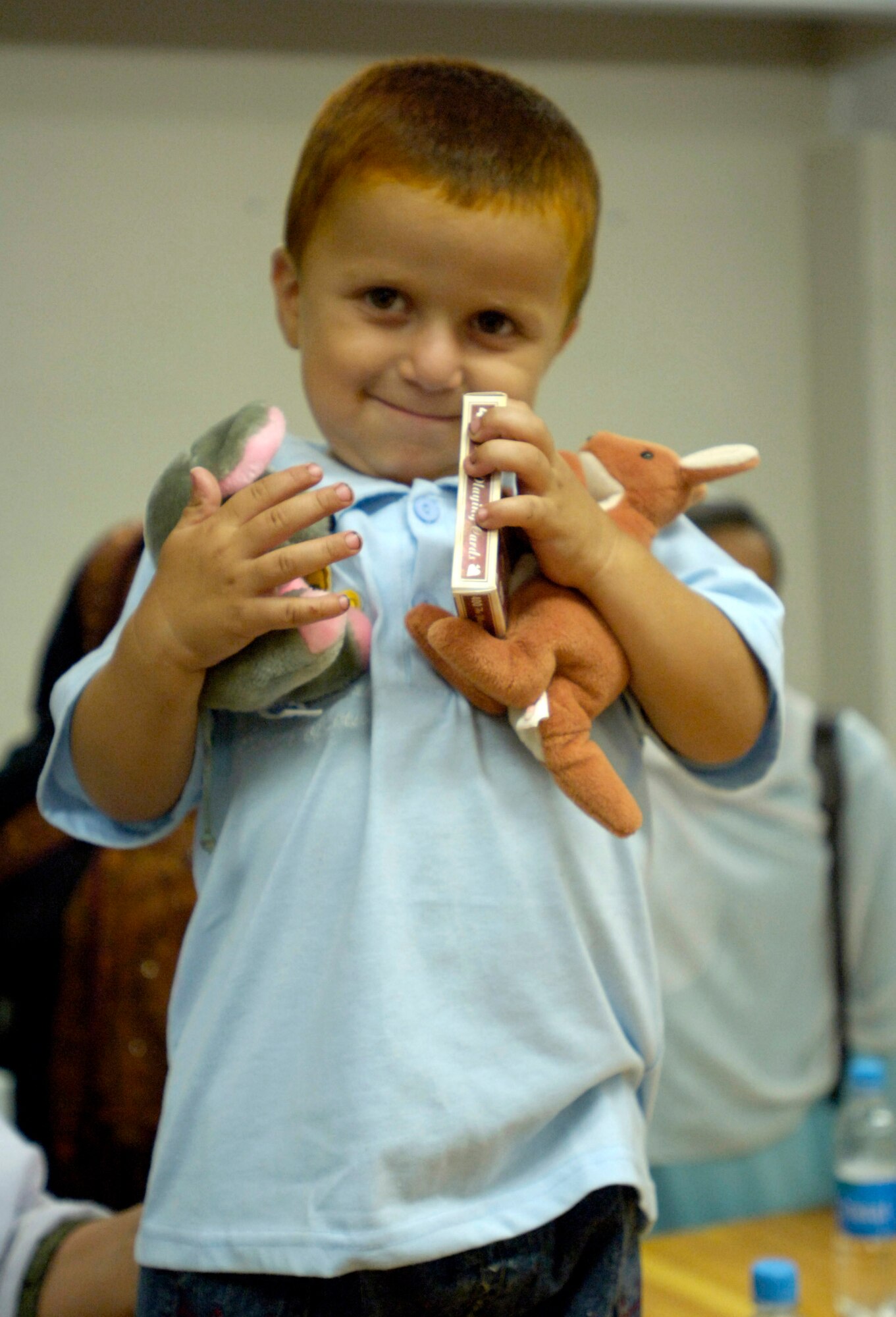 An Afghan child shows off gifts given to him during an afternoon tea Sept. 5 at Forward Operating Base Mehtar Lam, Afghanistan. Female Airmen and Soldiers assigned to the Laghman Provincial Reconstruction Team hosted the tea for influential Afghan women living throughout Afghanistan's Laghman province. (U.S. Air Force photo/Staff Sgt. Julie Weckerlein)