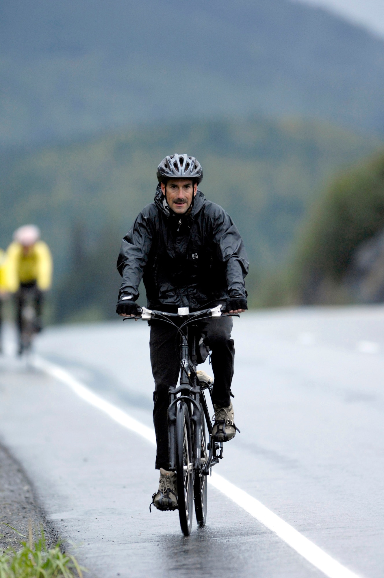 Chief Master Sgt. Jay Wilson participates in the Alaska Multiple Sclerosis Bike Ride Sept. 8 along a section of the Seward Highway in the Kenai Peninsula, Alaska. Consistent and sometimes heavy rains didn't prevent Chief Wilson, a member of the 703rd Aircraft Maintenance Unit, or other Airmen from Elmendorf Air Force Base, Alaska, from completing the two-day ride. People who took the 126-mile, round-trip ride saw extreme elevation gains challenging even the most experienced of the 200 riders. All proceeds from this event raised money for the National Multiple Sclerosis Society. (U.S. Air Force photo/Tech. Sgt. Keith Brown)
