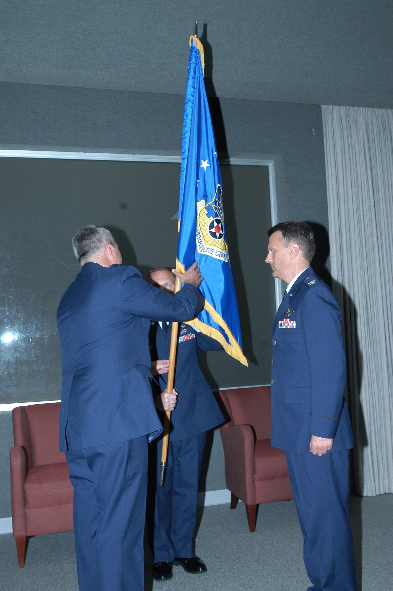 GRISSOM AIR RESERVE BASE, Ind., -- Col Randall Ogden, right, waits as Brig. Gen. Dean Despinoy, 434th Air Refueling Wing commander, prepares to hand him the 434th Operations Group flag during an assumption of command held during the September unit training assembly. (U.S. Air Force photo/Senior Airman Ben Mota)
