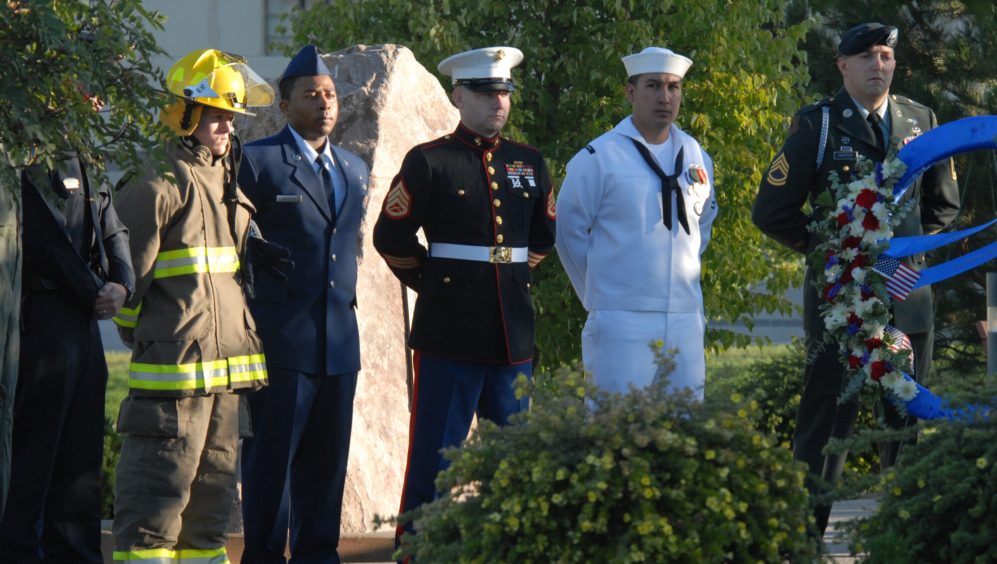 Servicemembers from each branch of the Armed Forces along with a fire and police department representative take part in a wreath and rose laying ceremonyat Malmstrom Air Force Base, Mont., Sept. 11, 2007.  The event was held to commemorate the sixth anniversary of the terrorist attacks on the United States Sept. 11, 2001. (U.S. Air Force photo/John Turner)