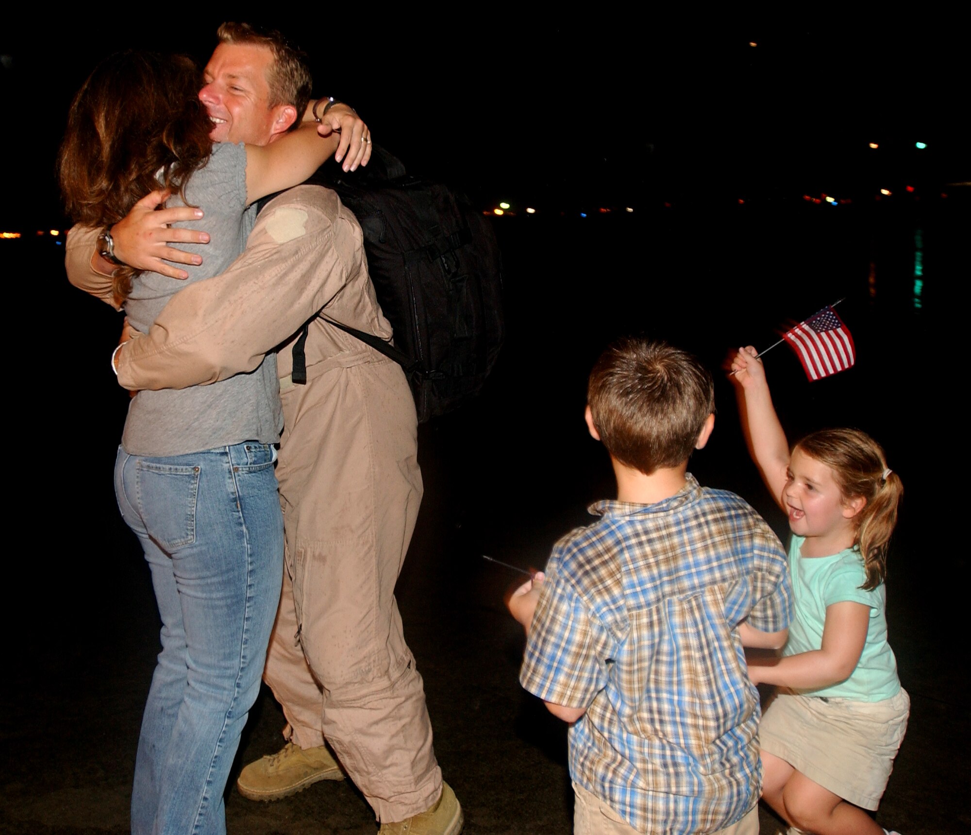 After being deployed for four months, a Master Sgt. from the 31st Rescue Squadron, is met by his wife Wendy and their two children after landing at Kadena AB, Japan, Sept. 10, 2007.
(U.S. Air Force photo/Tech. Sgt. Rey Ramon)


