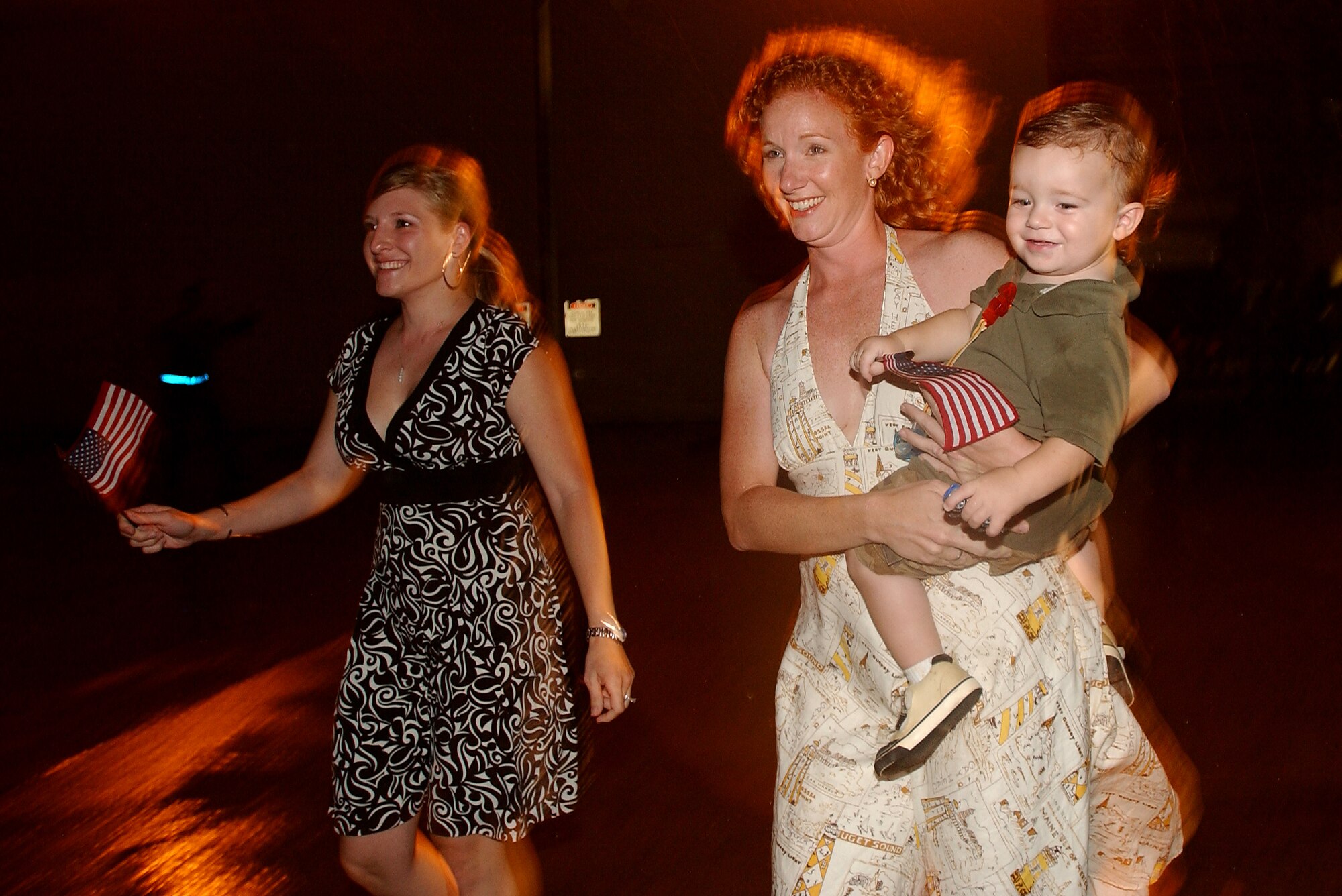 A couple of wives run to their husbands after they landed  at Kadena AB, Japan, Sept. 10, 2007. The 31st Rescue Squadron held a "Welcome Home" party after being deployed for four months.
(U.S. Air Force photo/Tech. Sgt. Rey Ramon)

